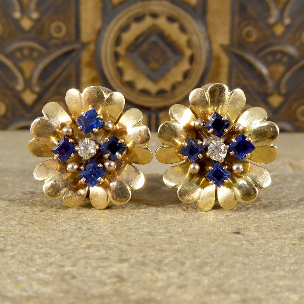 These cute little earrings host four square cut Sapphires with a Diamond in the centre of each earring. These unique earrings are formed in the shape of a flower from 18ct Yellow Gold and have omega clip backs.

Sapphire details:
Carat: 1.15ct