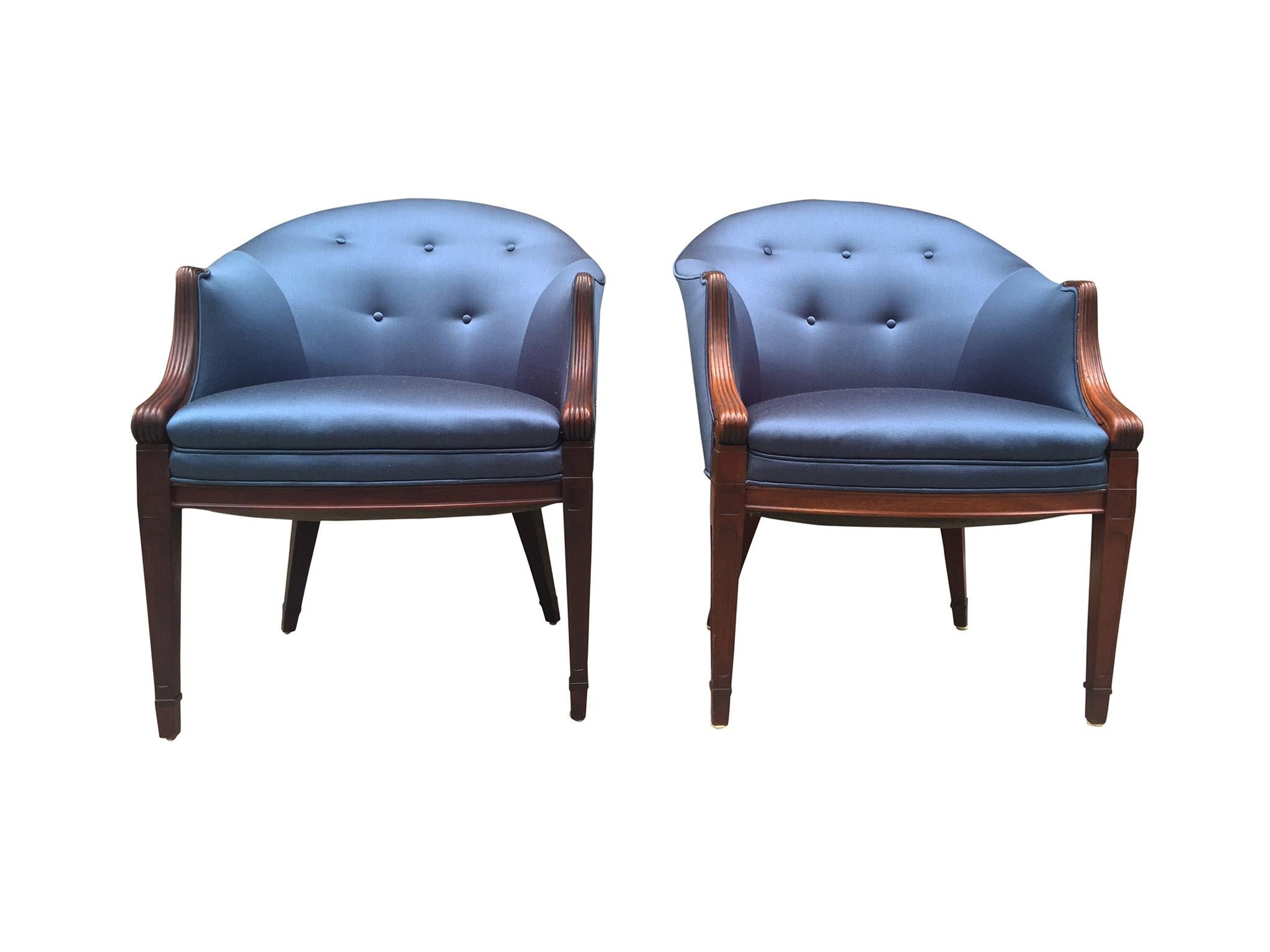 An elegant pair of easy chairs designed by Frits Henningsen, Denmark, 1940s. The chairs are comprised of mahogany. They are button-tufted and newly reupholstered in a fine, sapphire-blue silk. Henningsen's design brings together the smooth lines of