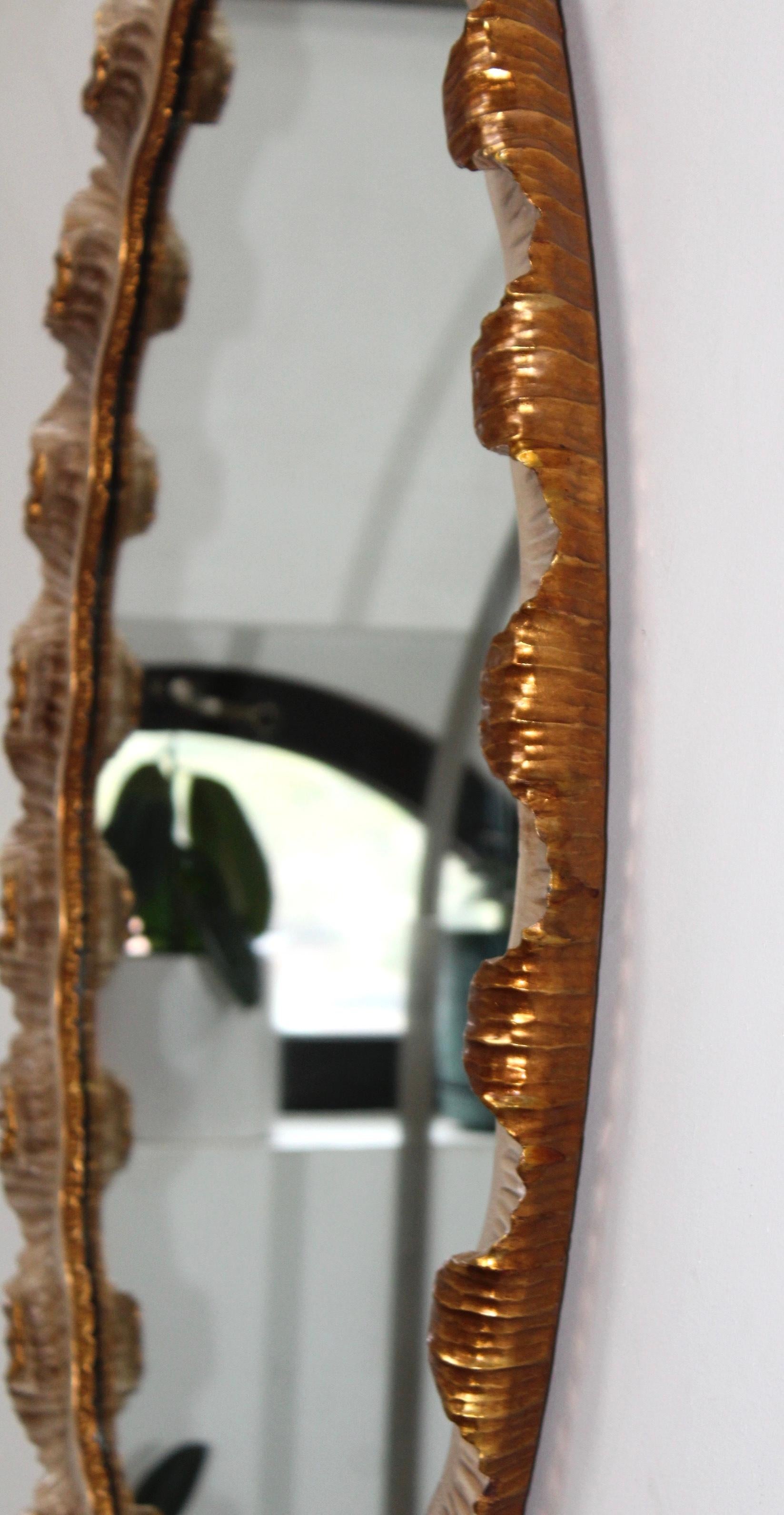 Stunning 1940's scalloped frame gilt oval Italian mirror, in vintage original condition with some wear and patina to the frame due to age and use.