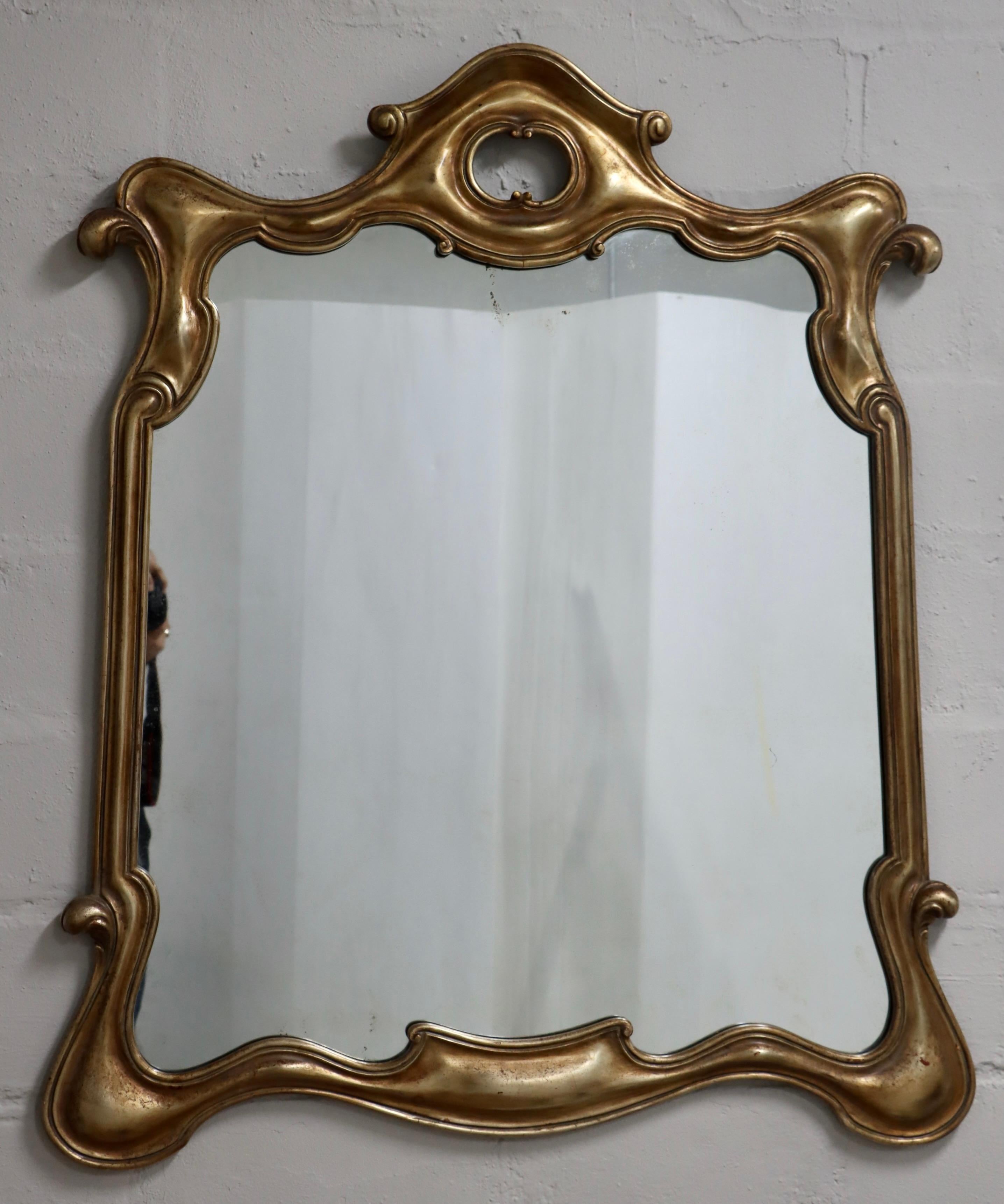 1940's large well made and very heavy sculptural gold and silver leaf Italian wall mirror, in vintage original condition with some wear and patina due to age and use, there is some wear to the frame and patina to the mirror due to age and use.