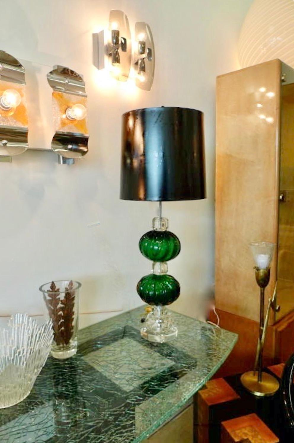 
This knock-out lamp has been completely rebuilt and rewired using vintage 1940's emerald green Seguso Murano glass balls the size of cantaloupe, crystal spacers, lucite base and high quality solid brass lamp fittings. 
Height adjustable shade