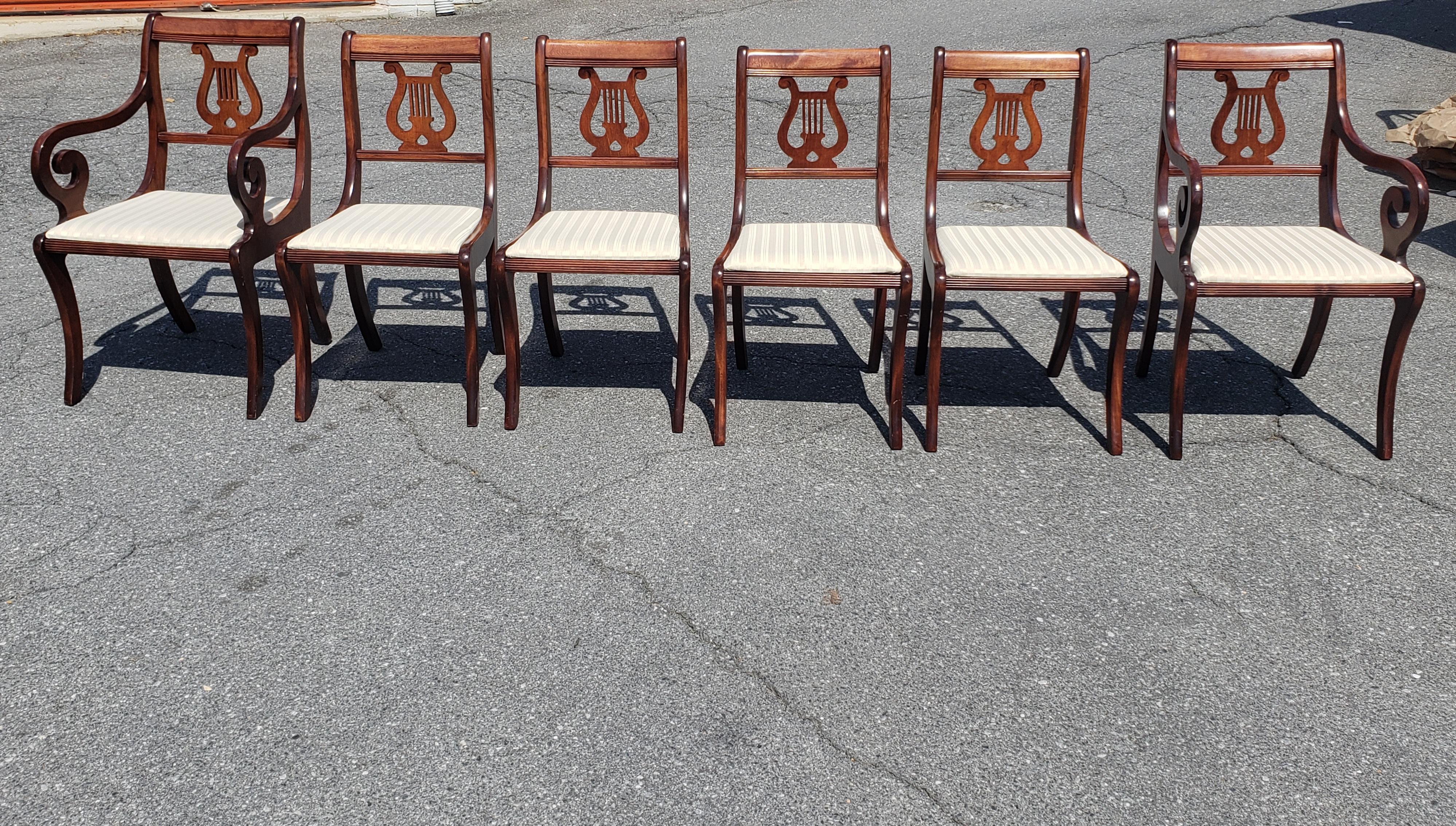 1940s Set of 6 Refinished Mahogany Klismos Lyre Back dining Chairs with 4 side chairs and two scroll arms captain chairs.
Cream color upholstered seats.