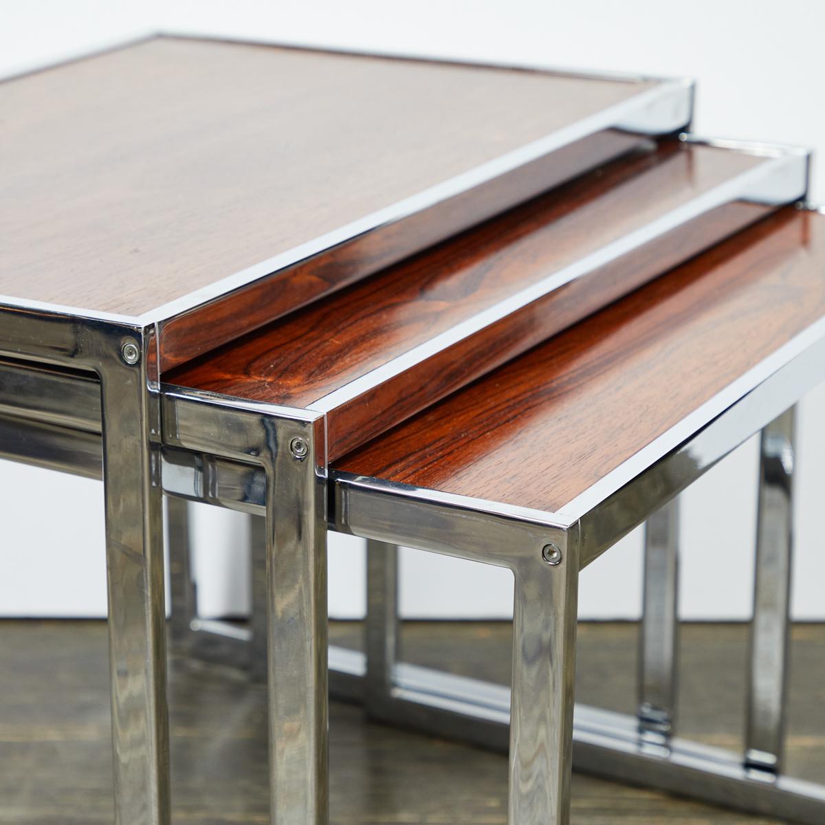Set of three English mid-century rectangular nesting tables with wood tops and chrome bases. Sexy and versatile, this set adds a touch of subdued glamour to any room.  

England, circa 1960

Dimensions: 25W x 16.5D x 19H