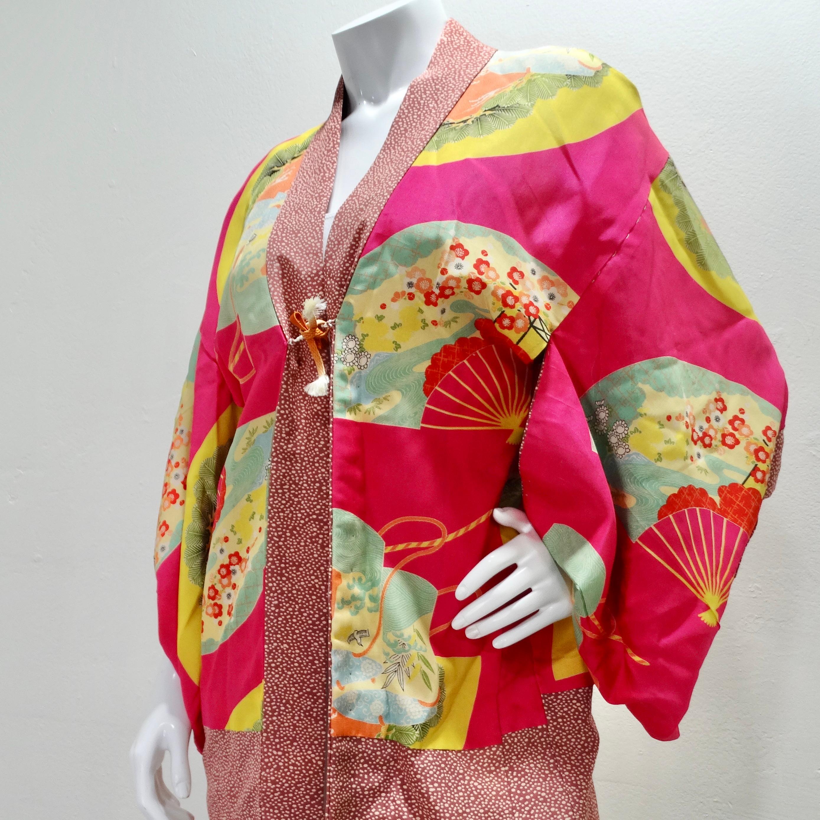 Introducing our 1940s Silk Multicolor Printed Kimono, a true work of art that beautifully fuses vintage charm and contemporary elegance. This mid-length kimono is a testament to timeless style and showcases a vibrant and intricate fan motif that