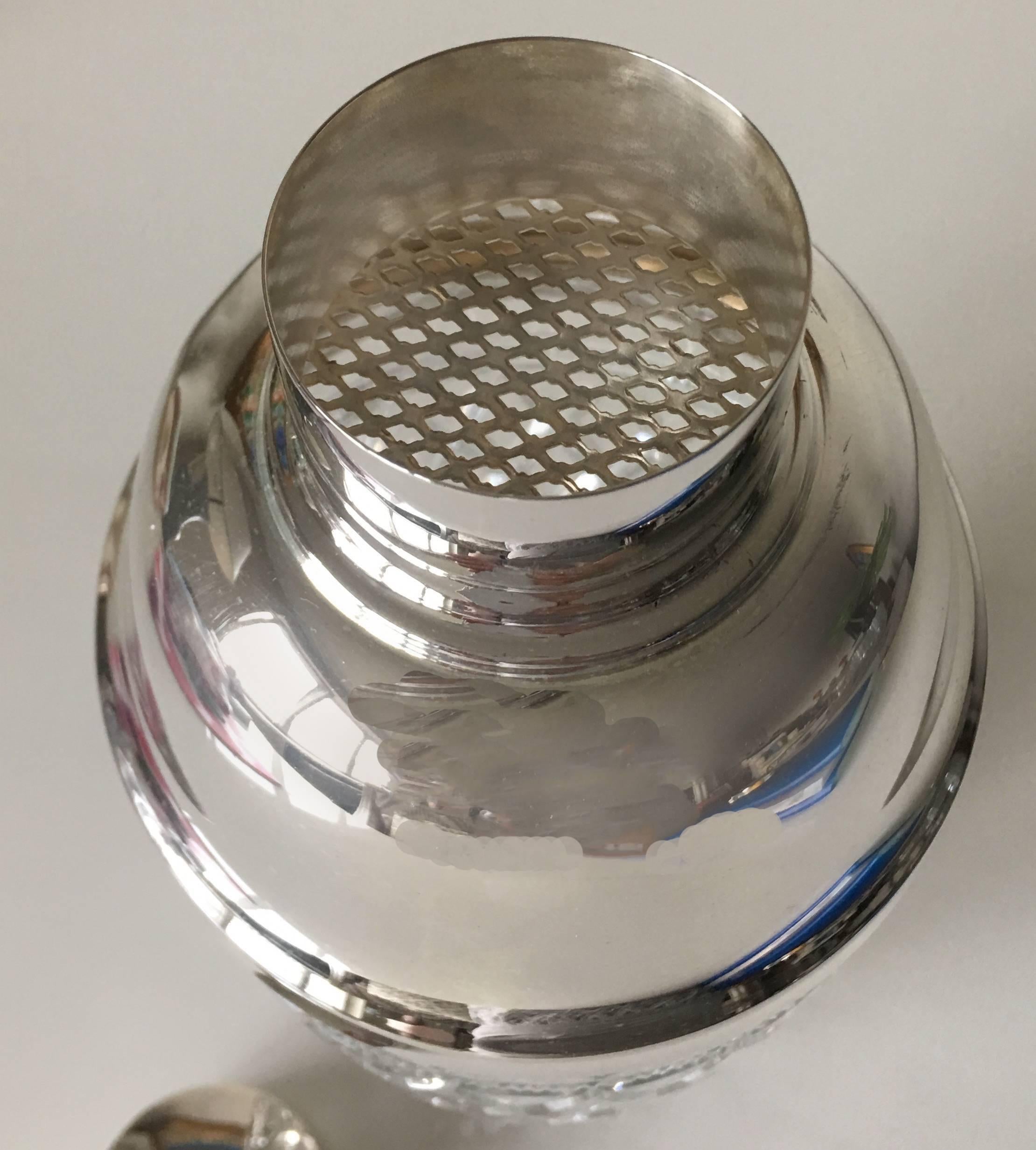 1940 silver plate cut crystal cocktail shaker. Lid and strainer are newly re-plated. No makers mark or signature.