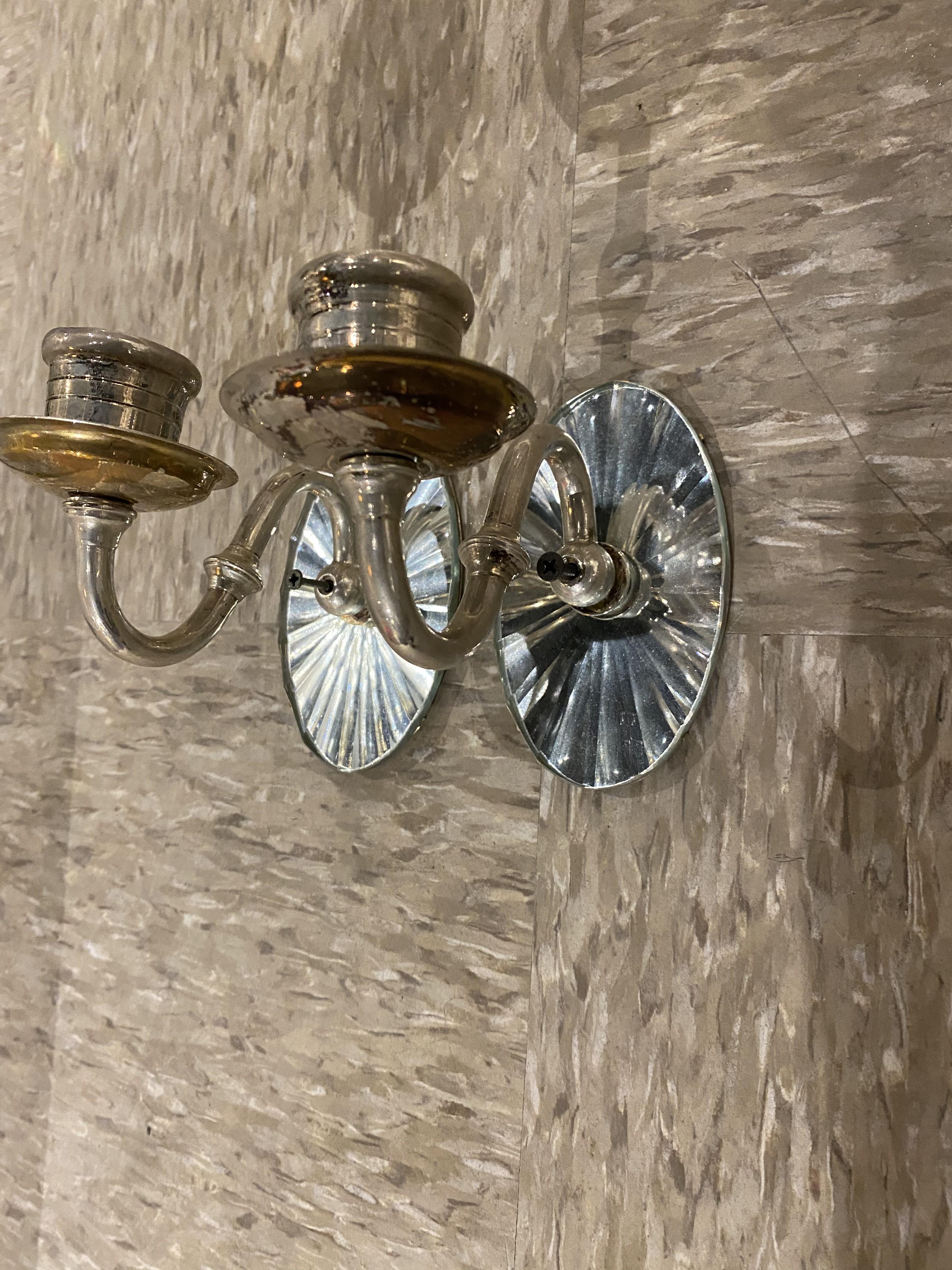 A pair of circa 1940's one light sconces with mirrored backplate.