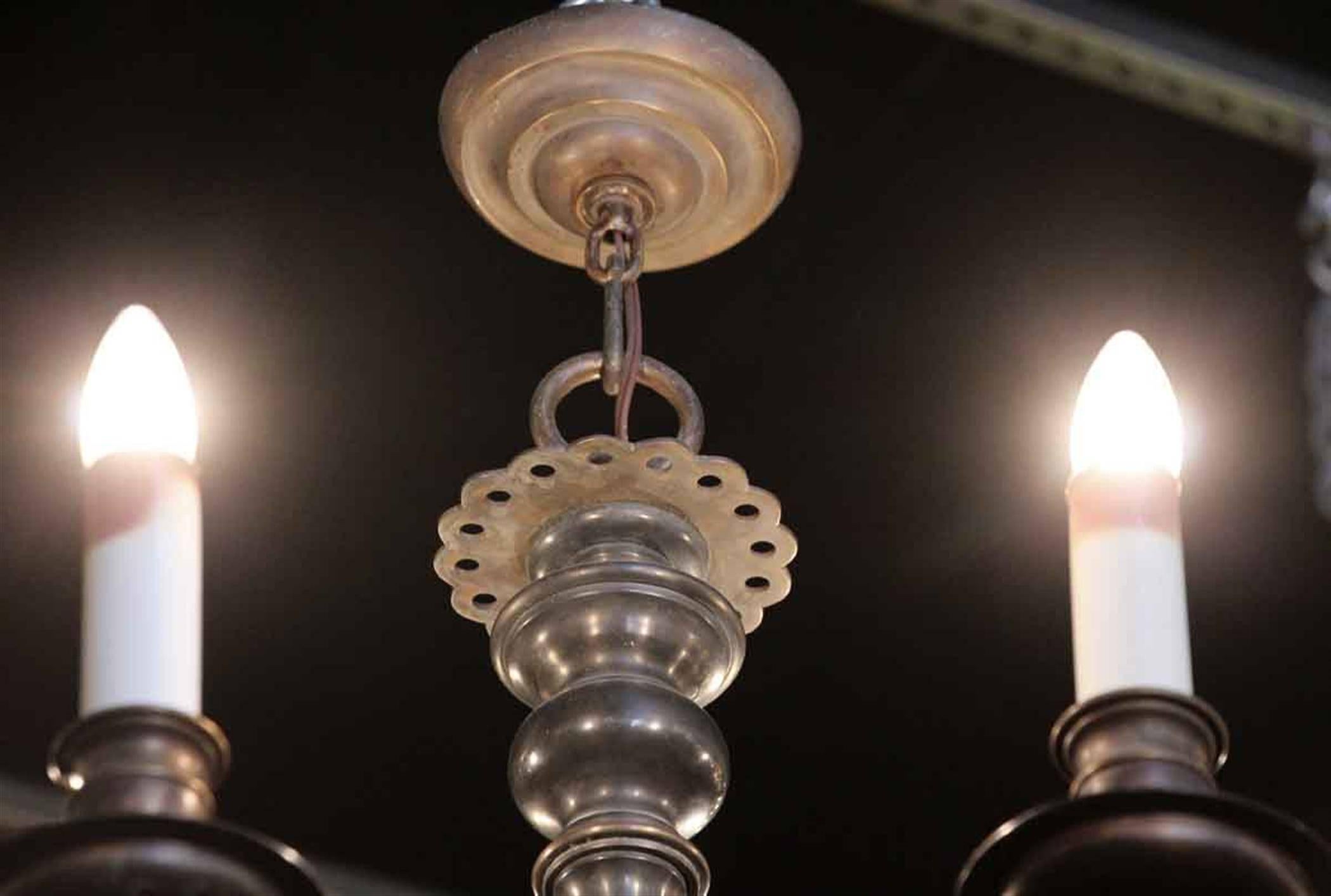1940s Williamsburg style six-arm bronze chandelier with a dark antique bronze finish. This can be seen at our 2420 Broadway location on the upper west side in Manhattan