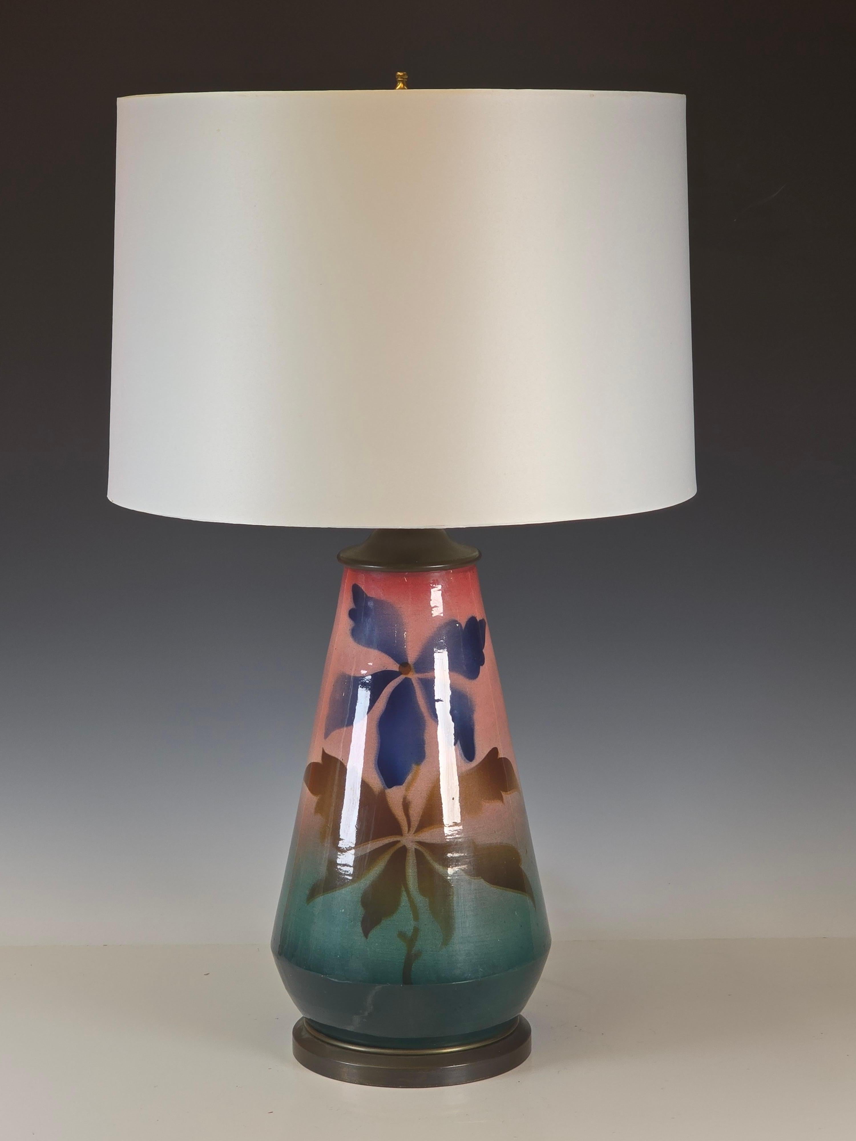 A pre WWli ceramic table lamp with a sprayed stenciled underglaze with a clear glaze covering it.   It almost glows like an enamel on copper finish, the sprayed underglaze really almost glows. It's from the mid to late 30s, unfortunately no marks
