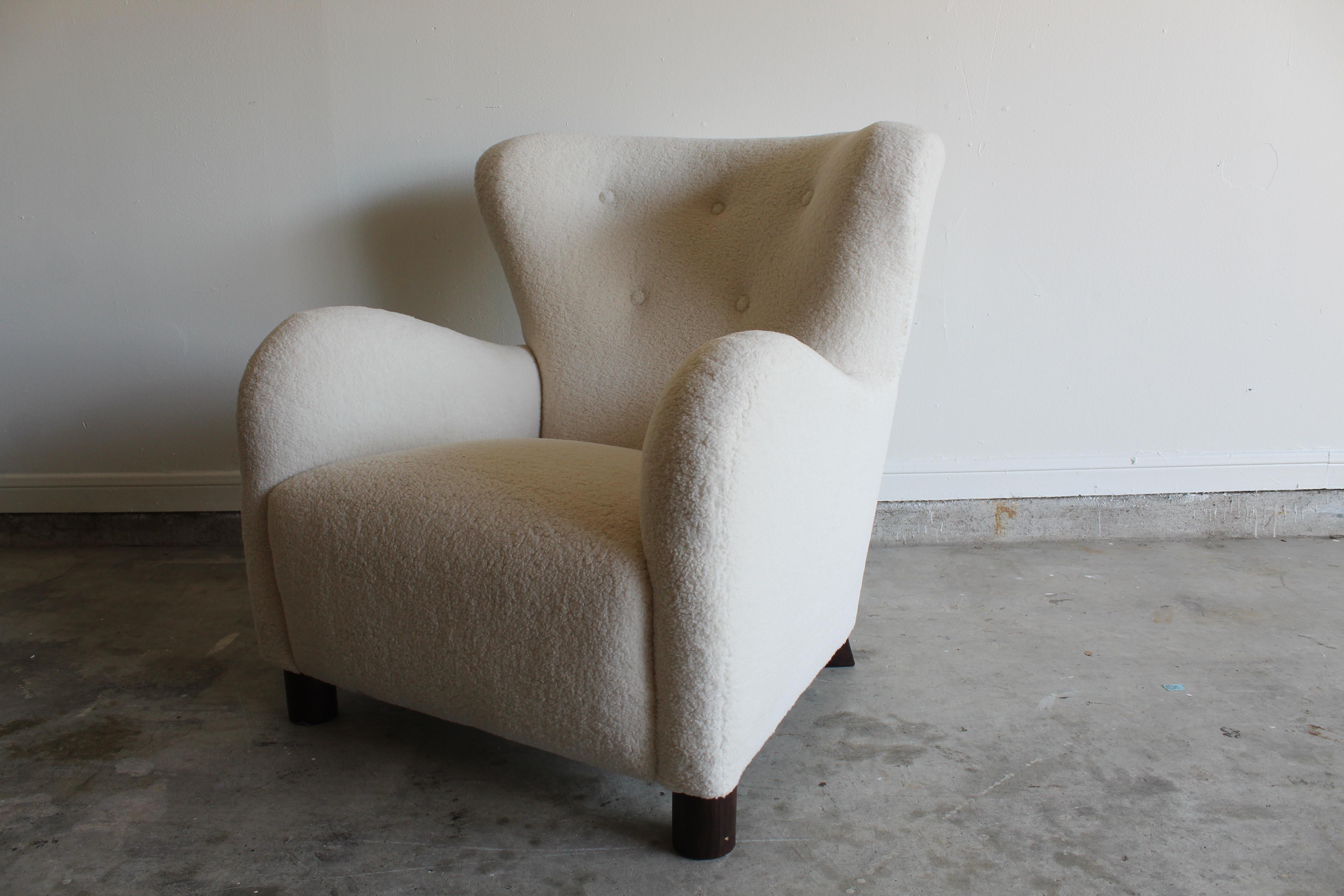 Stunning French club chair produced in the early 2000s in the style of the 1940s. Nice furry sheepskin upholstery with walnut legs. Minor scratches on legs upholstery in amazing condition.