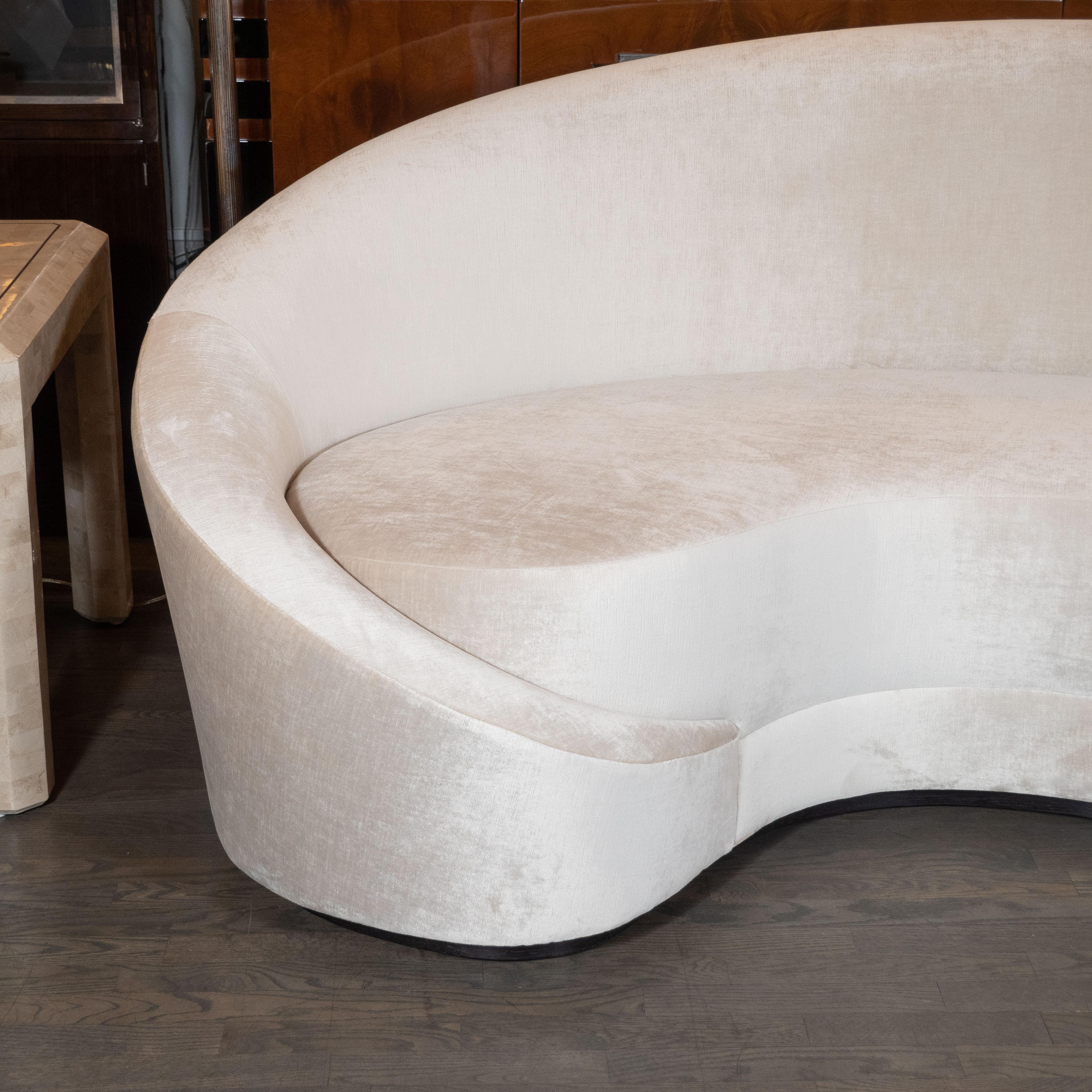 This stunning modernist sofa was handcrafted by artisans in New York state, by High Style Deco, based off a design from the 1940s. It offers elegant proportions and sweeping dramatic curves throughout. Combining the old world sophistication and