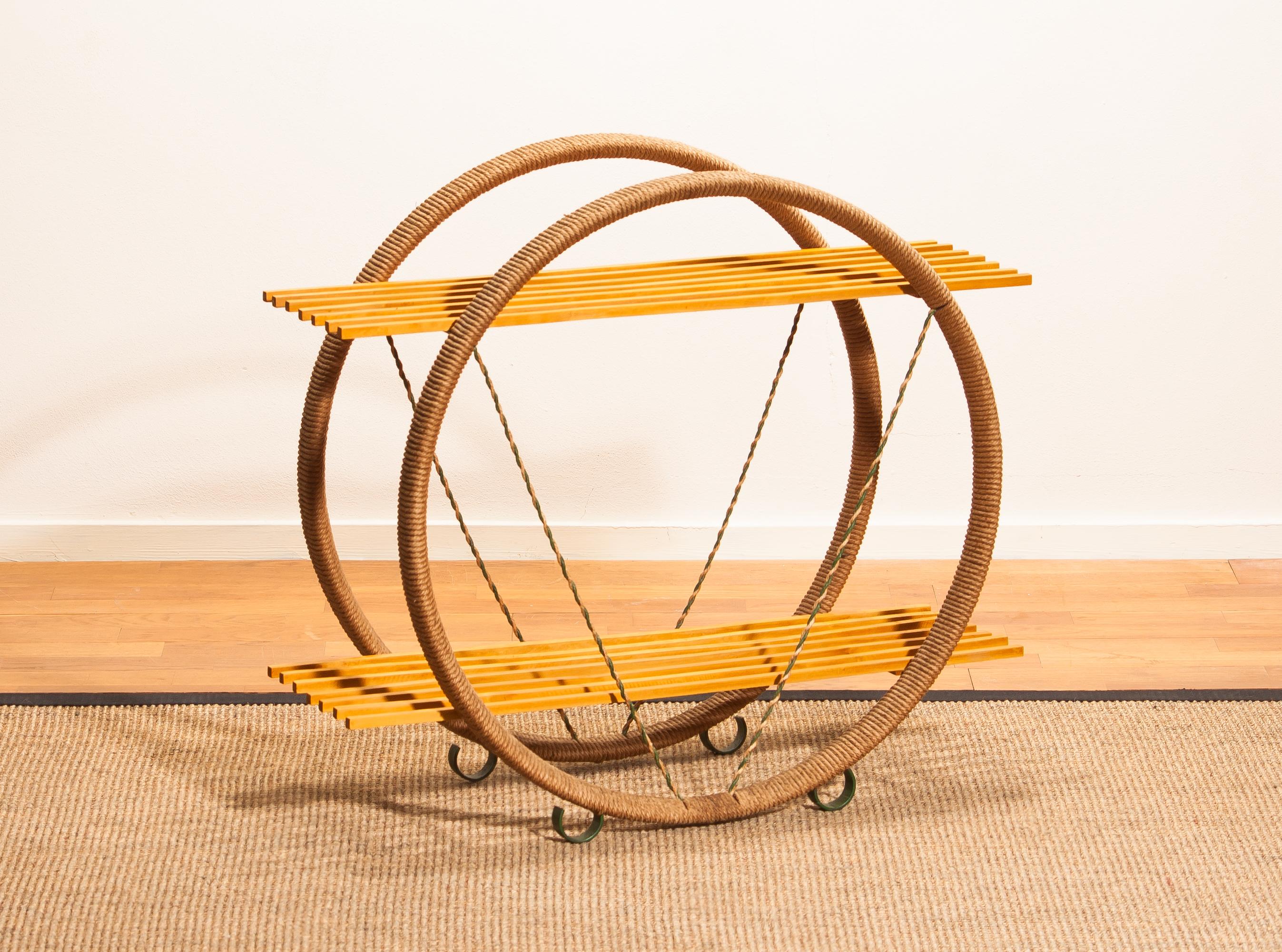 Extremely beautiful circular metal shelves cabinet wrapped with sisal/paper-cord.
This rare cabinet is made in Sweden.
Period 1940s
The dimensions are:
Total height 66 cm - 26 inch
Wide 74 cm - 29 inch
Depth 31 cm - 12 inch
ø of the circles are 64