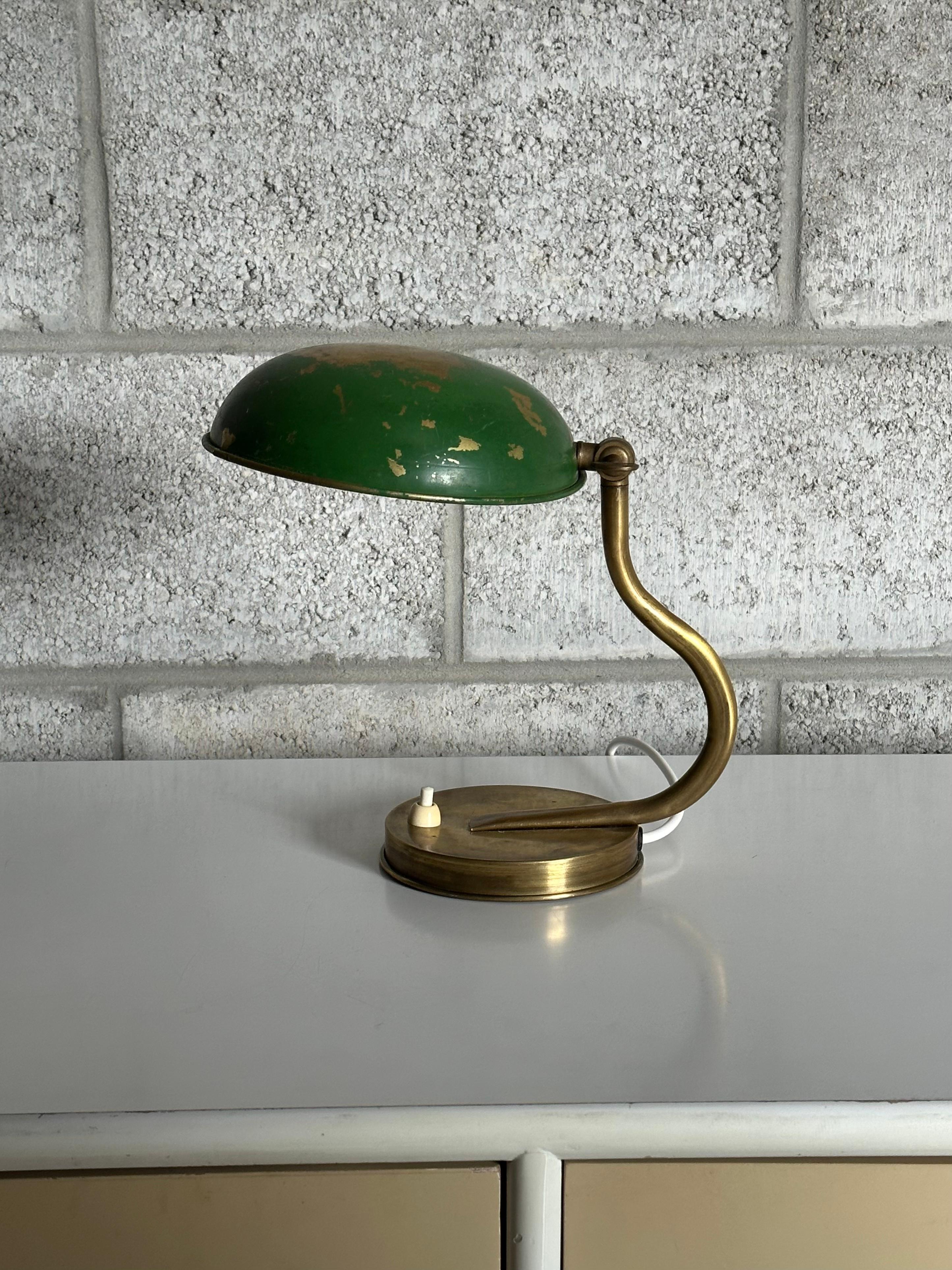A unique small table or wall lamp by ASEA and attributed to Hans Bergström. This lamps features a bottom with a cutout in the base plate that allows for it to be hung via a nail or screw on a wall. Wonderful organic form of the brass neck, and