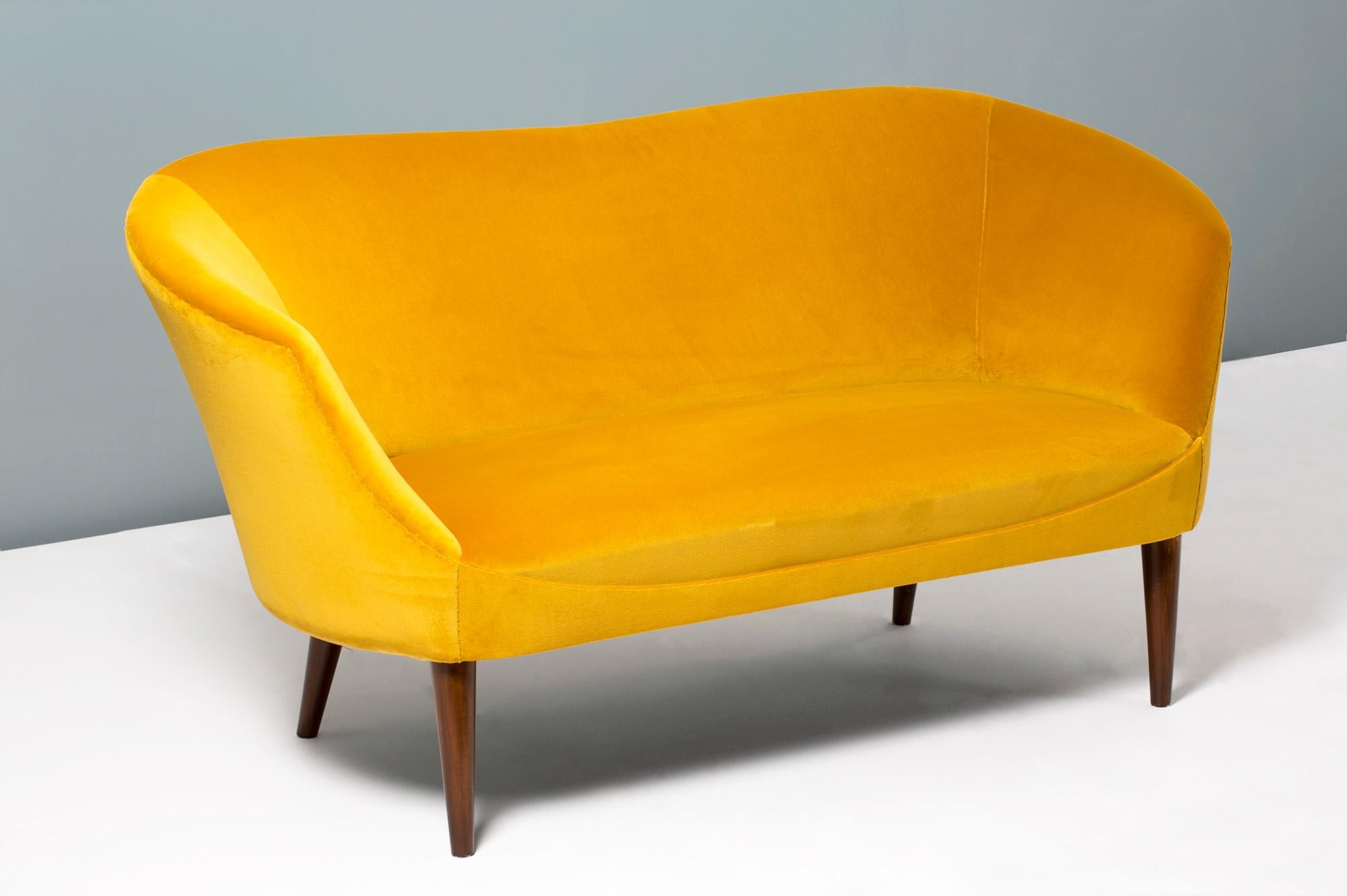Swedish-made love seat, circa 1940s.

This compact Art Deco inspired sofa bench was produced in Sweden between the 1940s and 1950s. It has been fully restored and reupholstered in our London workshop. The legs are stained beech and the sofa body