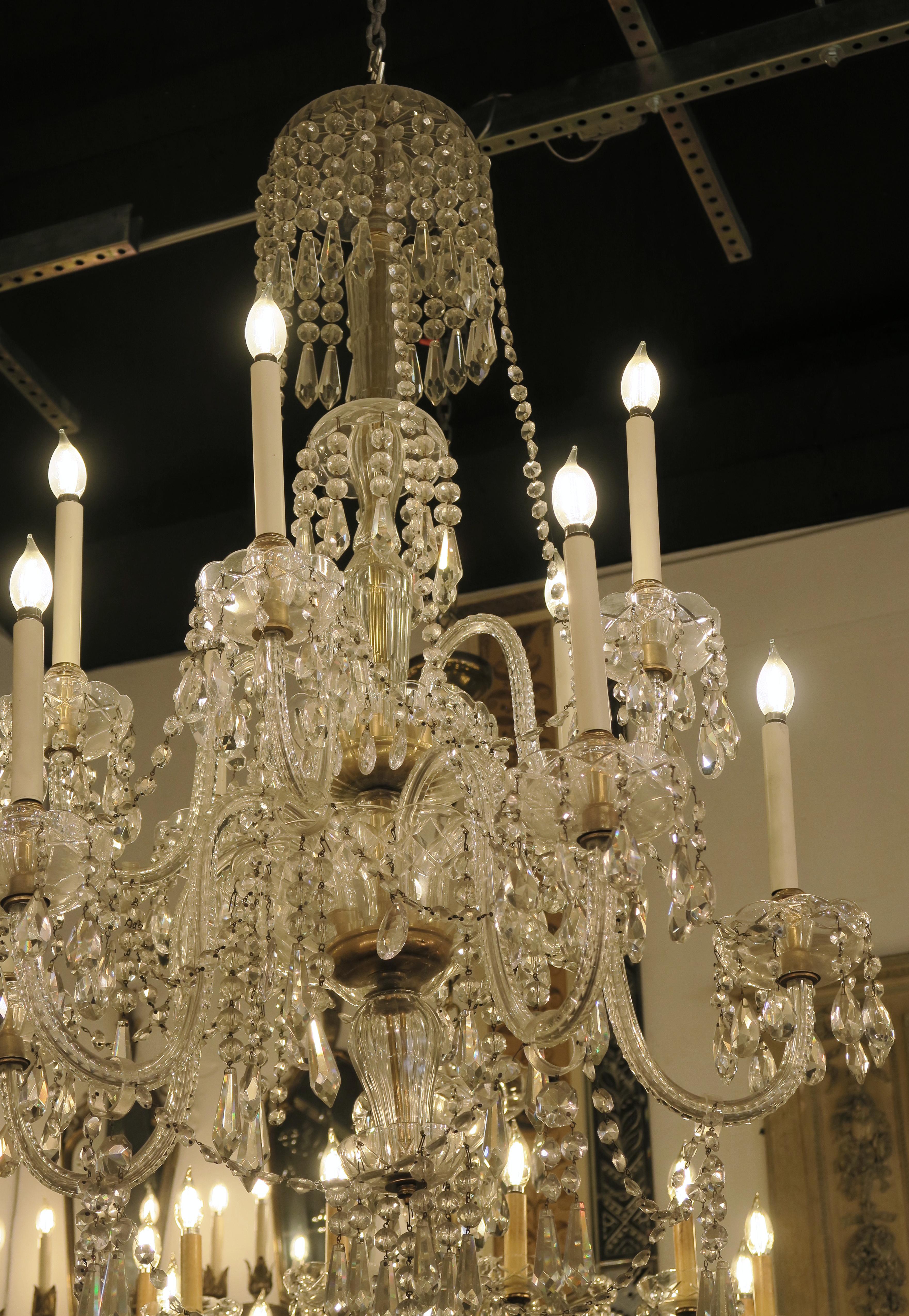 1940s gorgeous crystal chandelier with eight arms. Features an abundance of icicle crystals with brass details. This can be seen at our 2420 Broadway location on the upper west side in Manhattan.