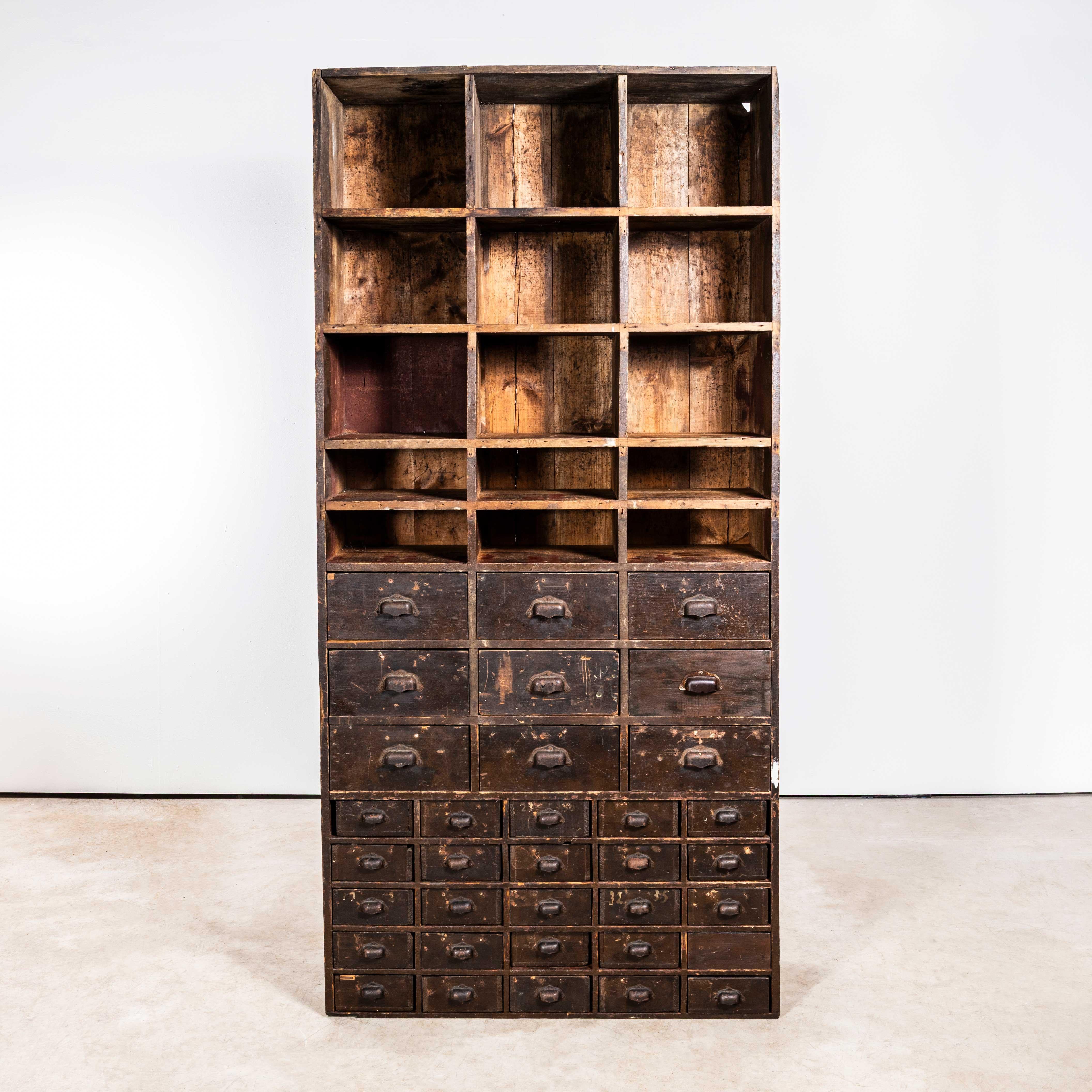 1940’s Tall French Workshop Shelving Unit – Thirty Four Drawers. 

Sourced in France this is a practical piece of storage, the bottom has nine large drawers and 25 small drawers. The top has a number of pigeon holes. Made entirely of solid pitch the