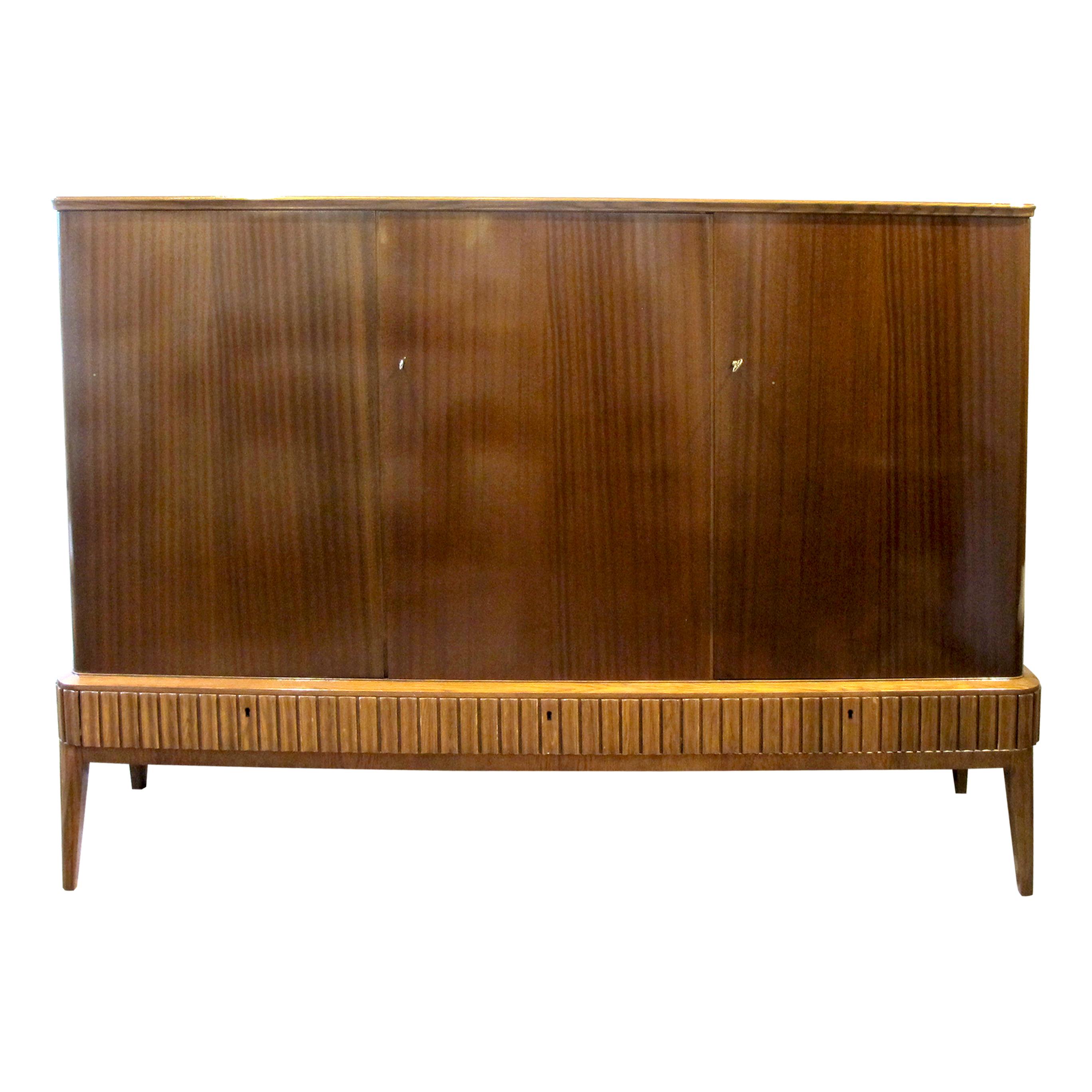 Exceptional elegant and tall Cuban mahogany sideboard/cabinet in great condition produced by Blomstermåla Möbelfabrik in Sweden in the 1940s. This well-made cabinet offers plenty of storage with double doors with adjustable shelves on the left and a