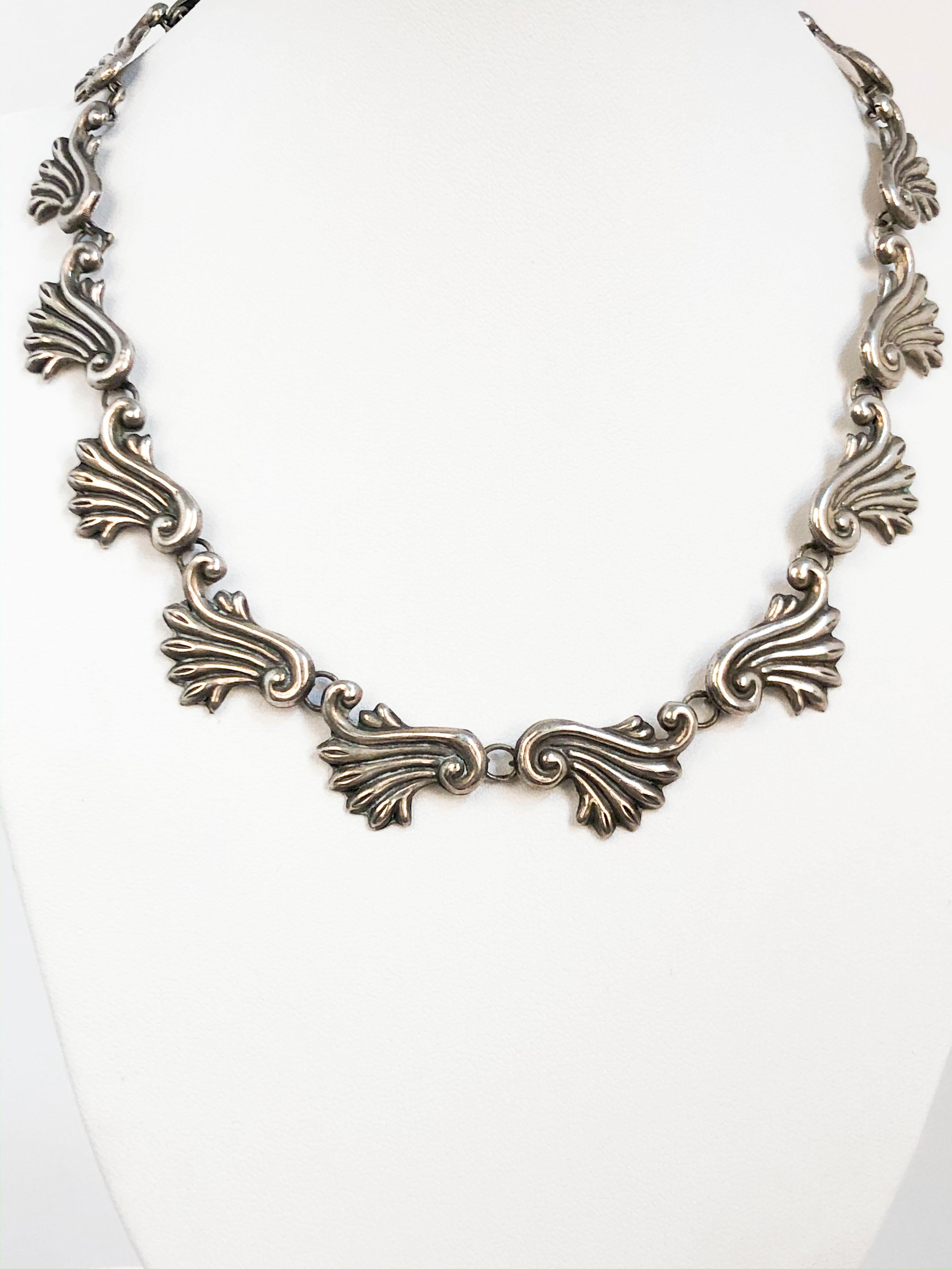 1940s Taxco silver necklace featuring ornate links that are orientated in a symmetrical order. 