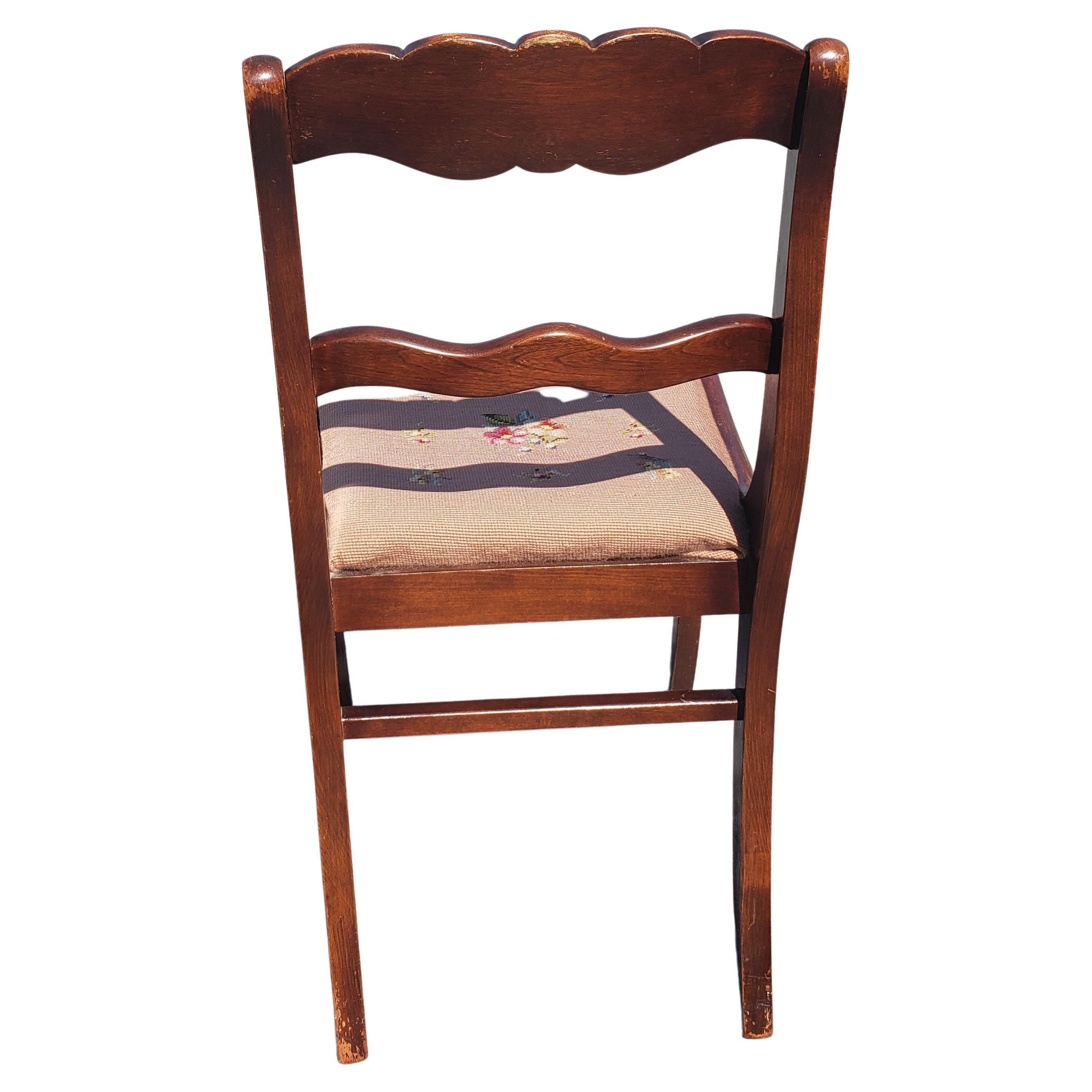 A set of four 1940’s Tell City Chair Company mahogany Duncan Phyfe rose back chair with needlepoint seat 
Measures 17.5