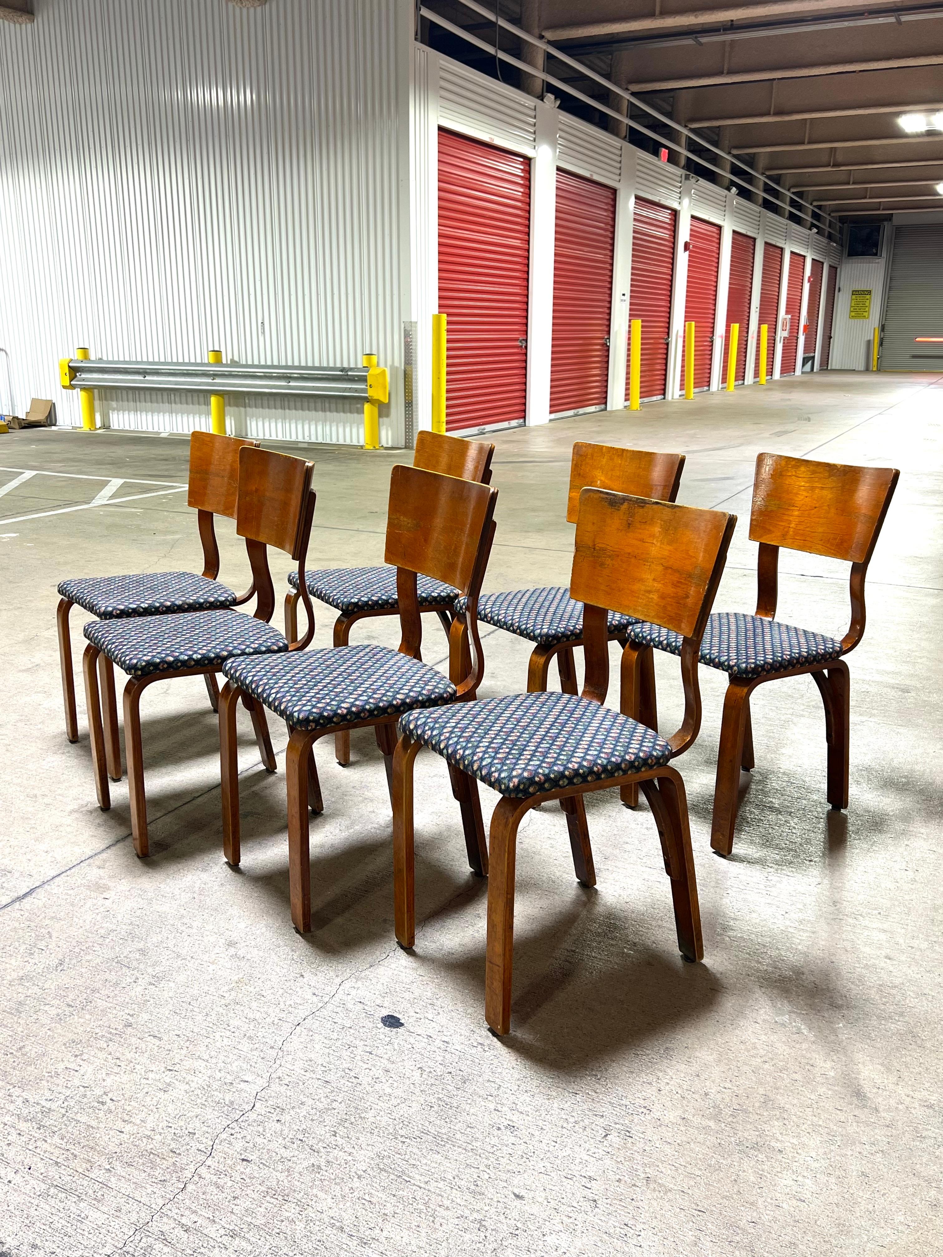 This exceptional set of early Thonet bent plywood dining chairs dates back to the 1940s. One of the chairs retains its original Thonet tag.
