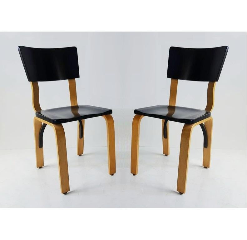 Vintage Michael Thonet birch bentwood dining chairs. The set comes with ten chairs in golden birch bentwood with black lacquered backrests and seats. Stamped 
