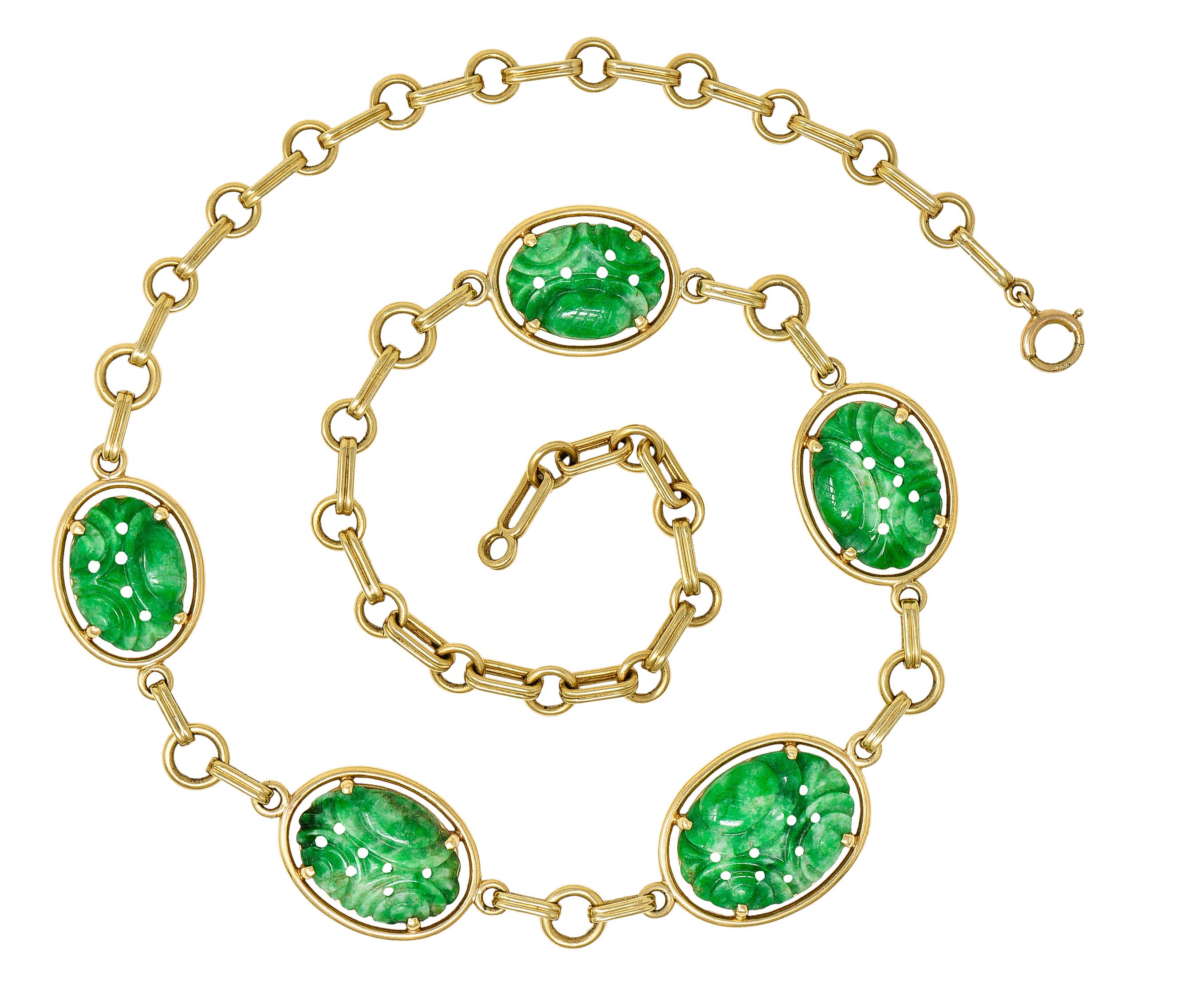 Necklace is comprised of circular links alternating with ribbed spacer bar links. While centering five carved jade oval stations - jade measures from 20.0 x 15.0 mm to 16.0 x 12.0 mm. Well matched, opaque, and strongly mottled green to pastel green