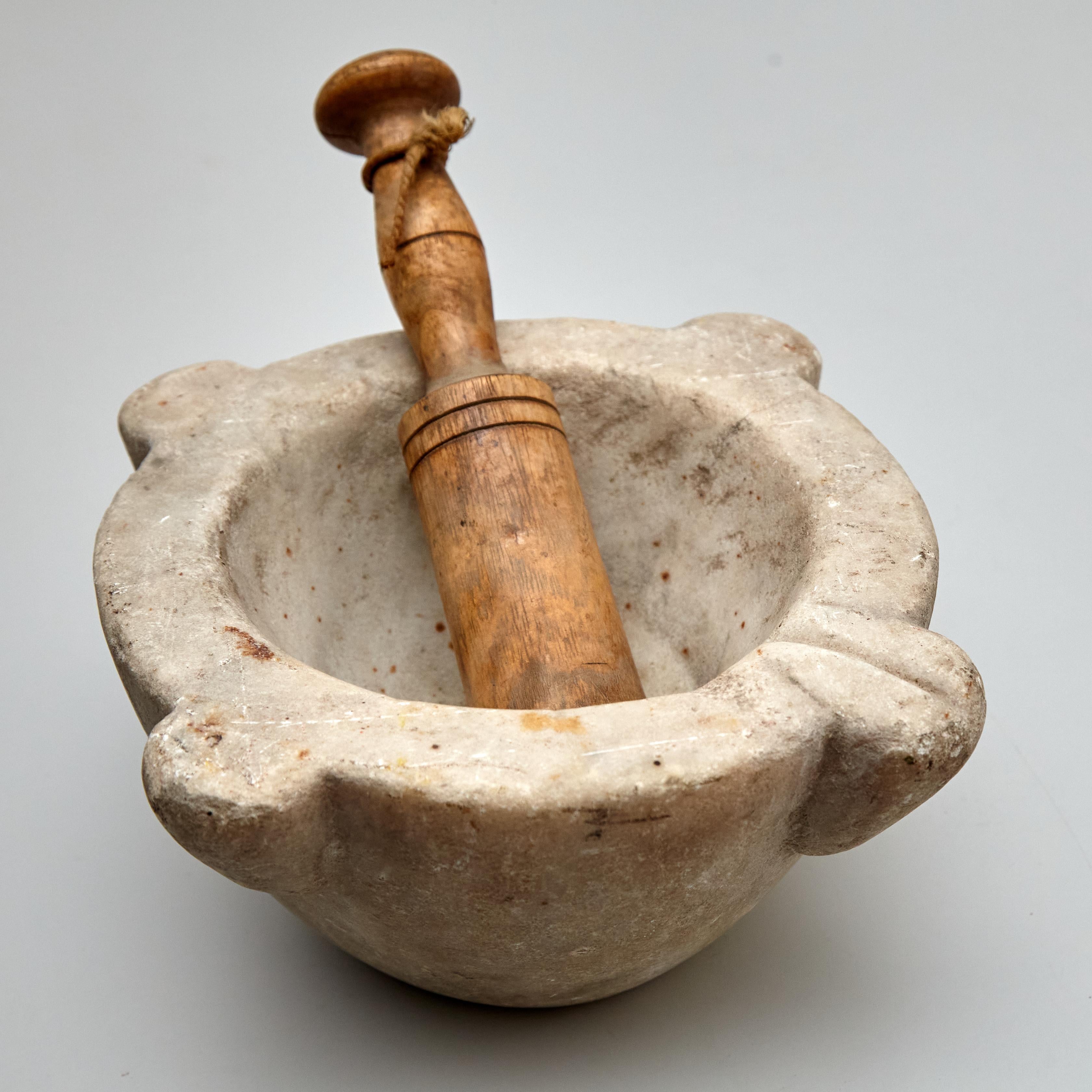 Introducing a genuine piece of history with this Traditional Early XXth century Spanish Mortar, circa 1940. Manufactured in Spain, this charming mortar is crafted from stone and wood, showcasing the beauty of Classic Spanish craftsmanship. In
