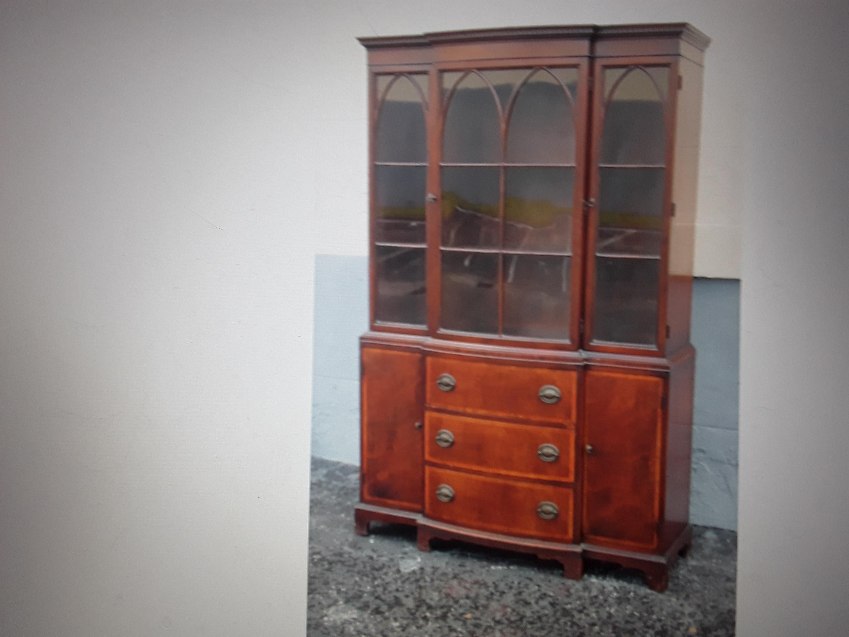 1940's Traditional style Tall Mahogany China/ Display Cabinet. The woodwork is beautiful. There is a lot of storage. Glass plane front!. Please look closely at pictures as they tell the story.