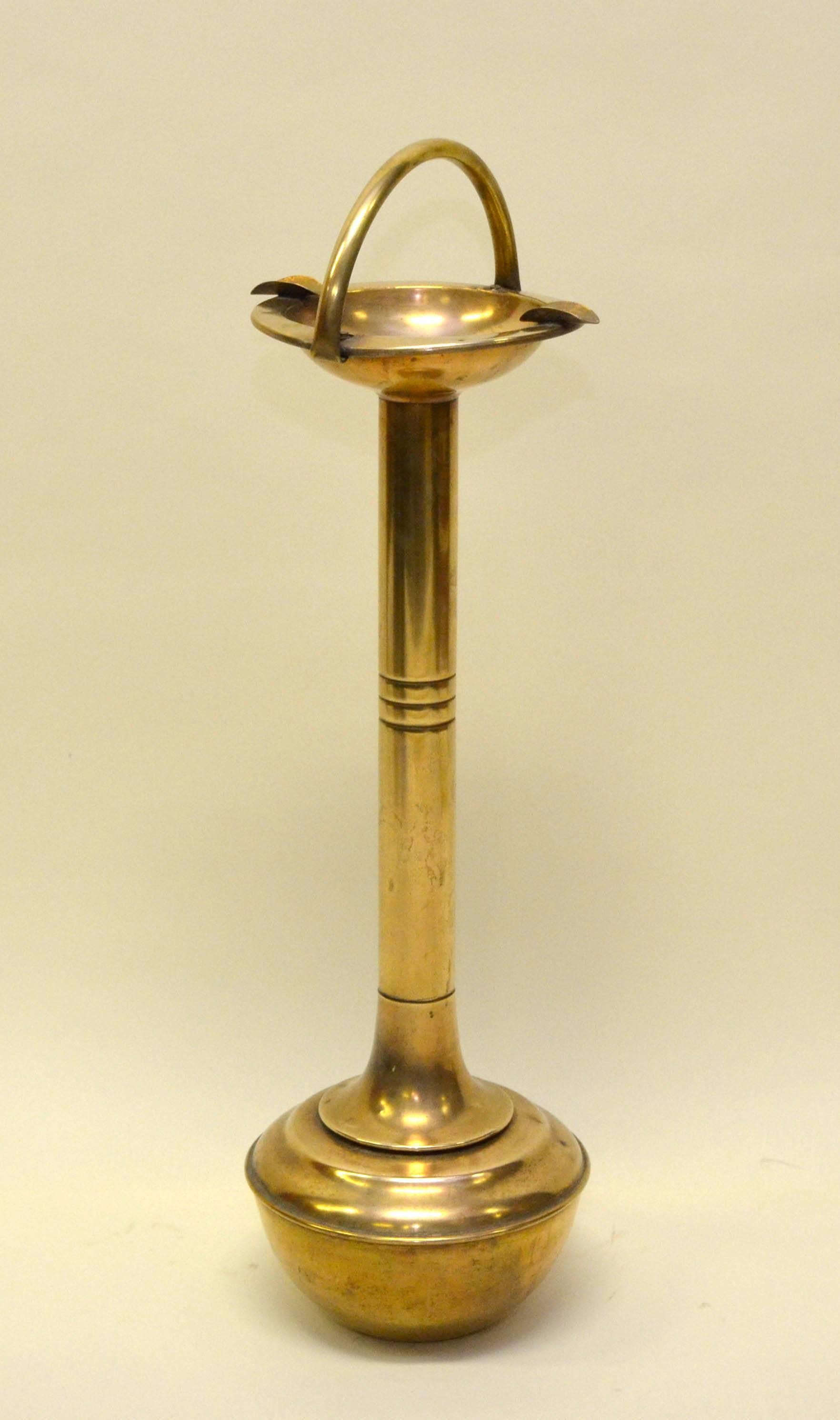 Probably English tall brass ashtray with bounce back base.
The base can be spinned around but never allows the ash to fell out from the tray.