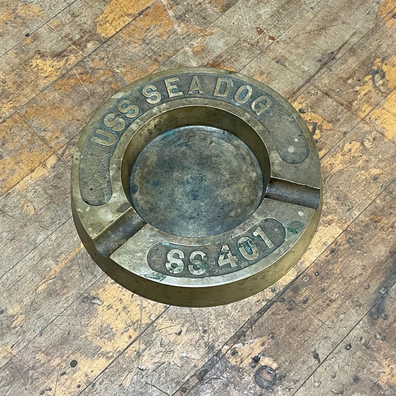 USS Sea Dog (SS-401) Service from 1943 to 1968. This Submarine served in the pacific in World War 2, and the Korean War. 
 This is not a souvenir ashtray. This is a very heavy object made for use in at sea on the submarine. No damages, just