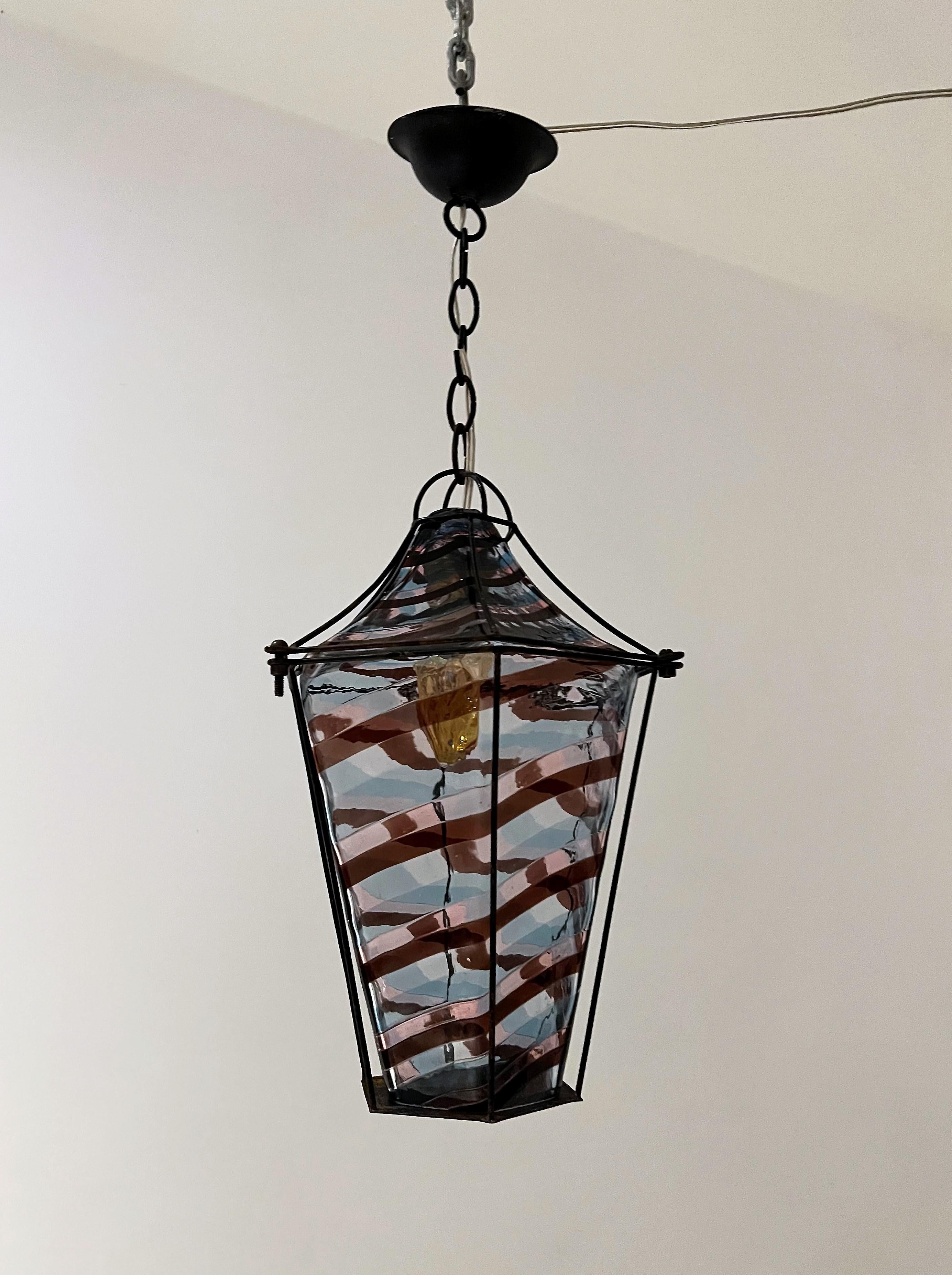 Designer:
FULVIO BIANCONI (1915-1996)

Fasce Ritorte Ceiling Light / lantern manufactured by Venini in multicoloured Murano blown glass and steel armature lacquered in black (paint is original and chipped but can be re-laquered upon request by the