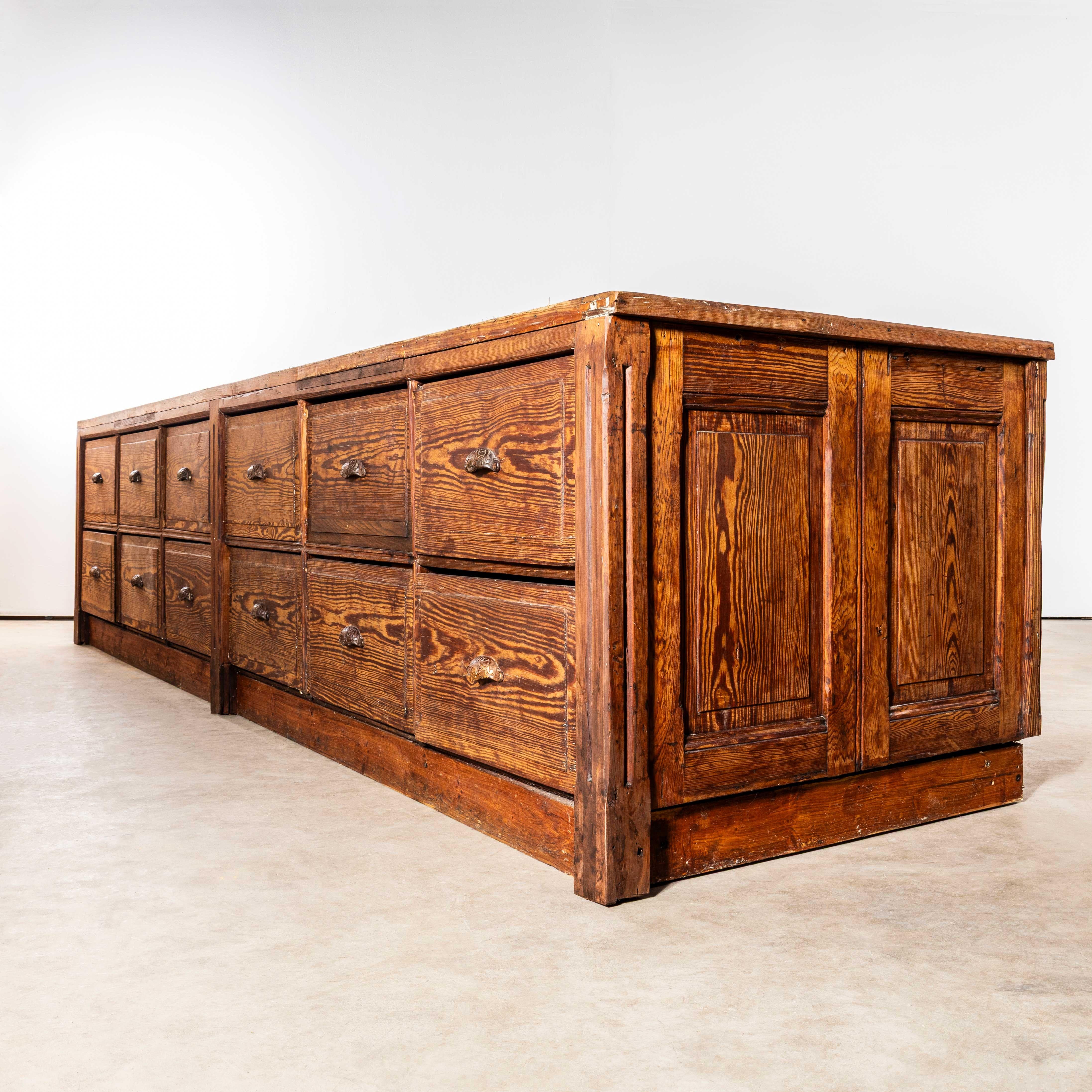 1940’s Very Large French Hardware Bank Of Drawers – Twelve Drawers. Massive bank of drawers sourced in France. The cabinet is made from a highly figured pitch pine, beautifully made with solid reeded end pillars and double panelled ends, even the
