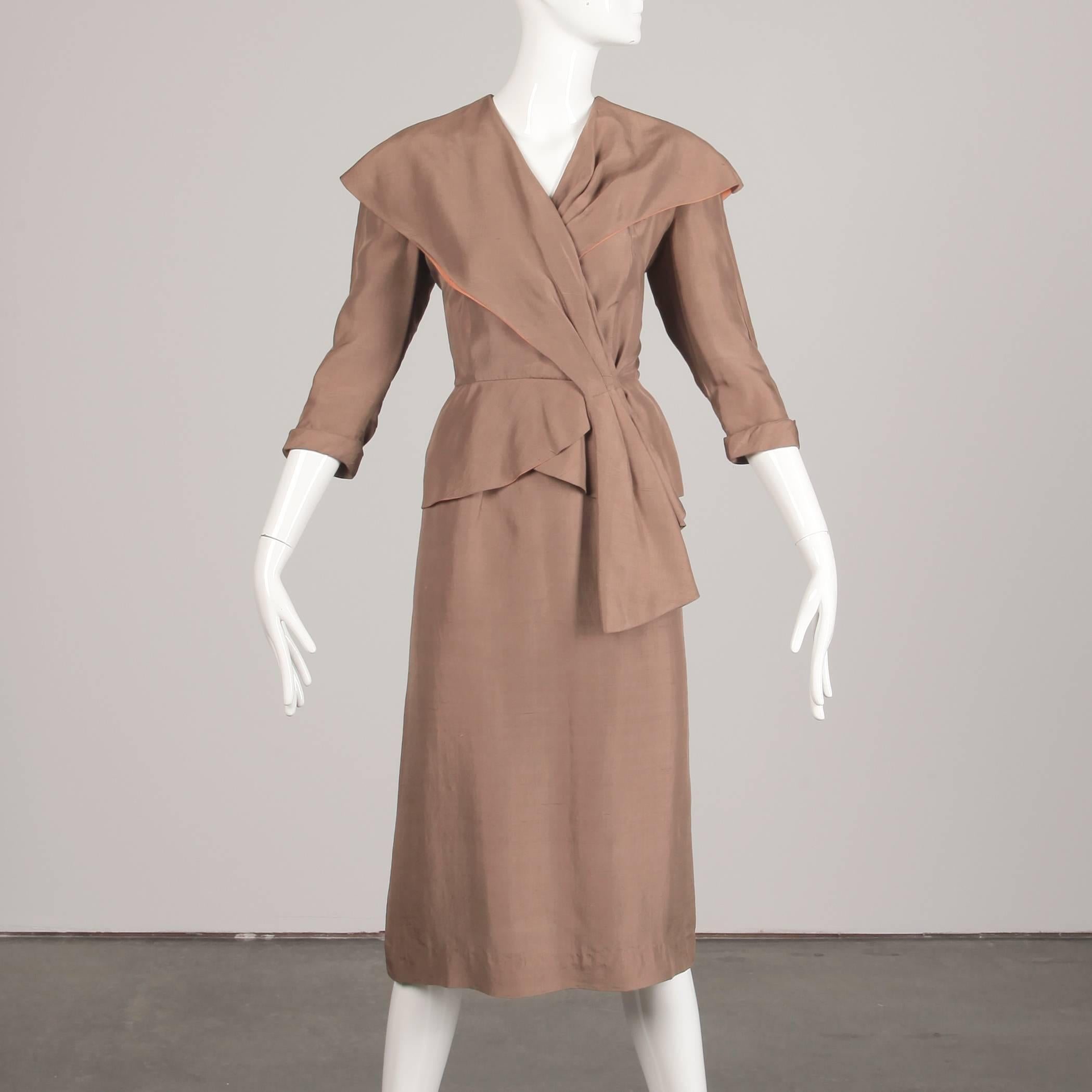 Asymmetric beige silk women's suit from the 1940s. The skirt is unlined with side metal zip and hook closure. 100% silk. Fits like a size small. The waist measures 25.75