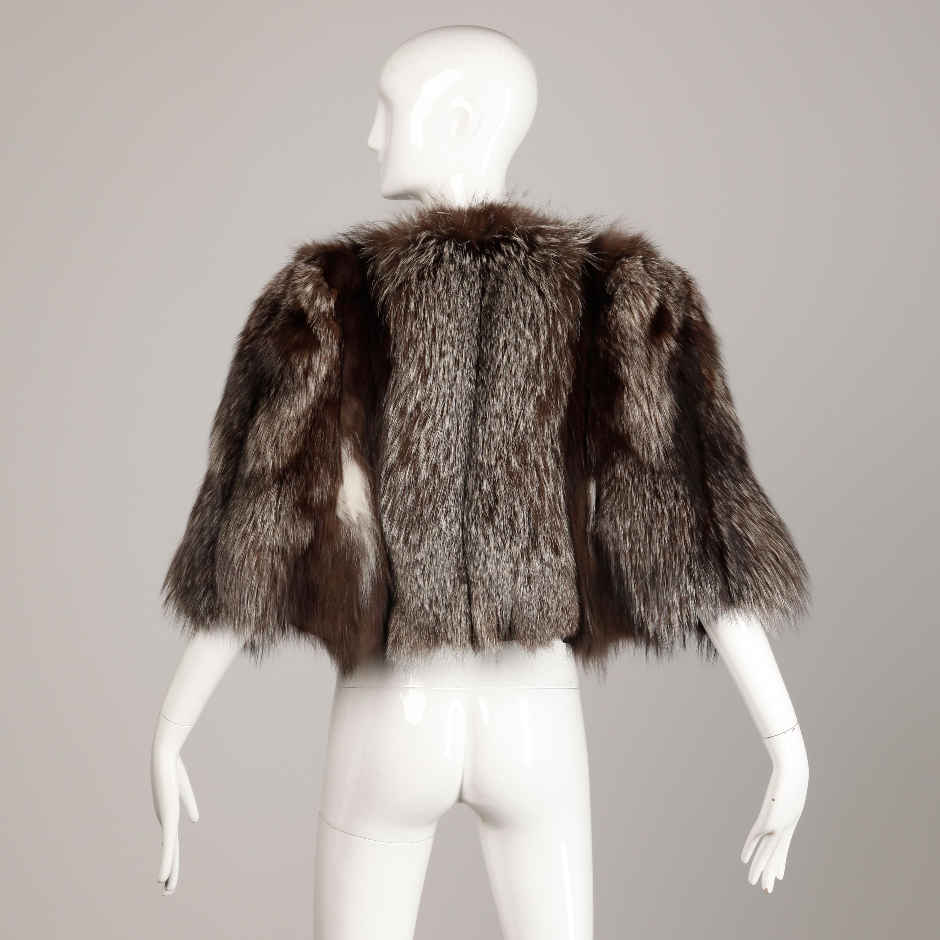 Beautiful vintage 1940s crystal fox fur cape with arm slits and black satin lining. Gorgeous coloring with a flattering design. Excellent vintage condition with normal signs of wear for a fur of this age. One of the arm straps is missing from the
