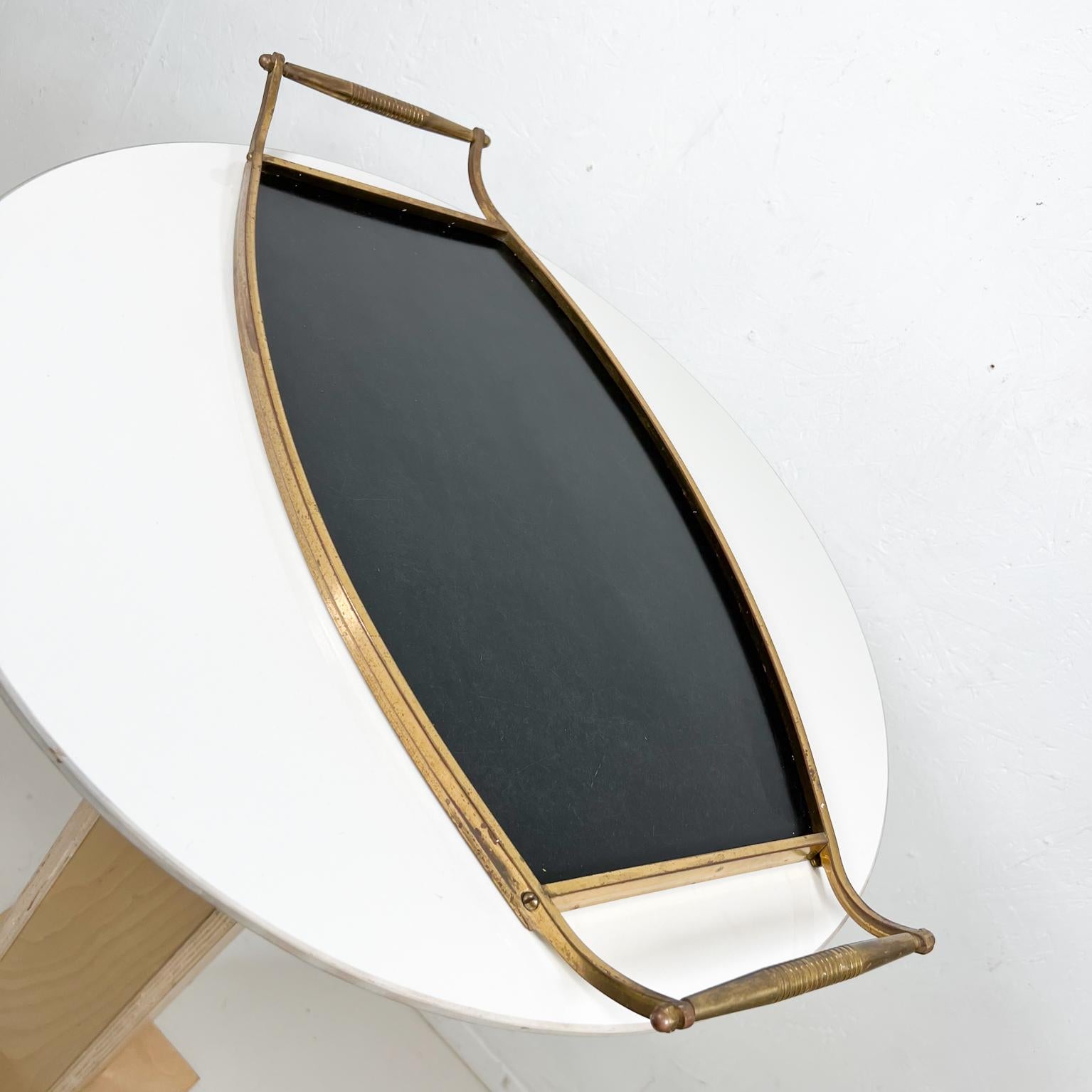 1940s Elegant black laminate on brass service tray with handles.
Measures: 24.5 W x 11.75 D x 2.
Preowned original unrestored vintage condition.
See images provided please.


