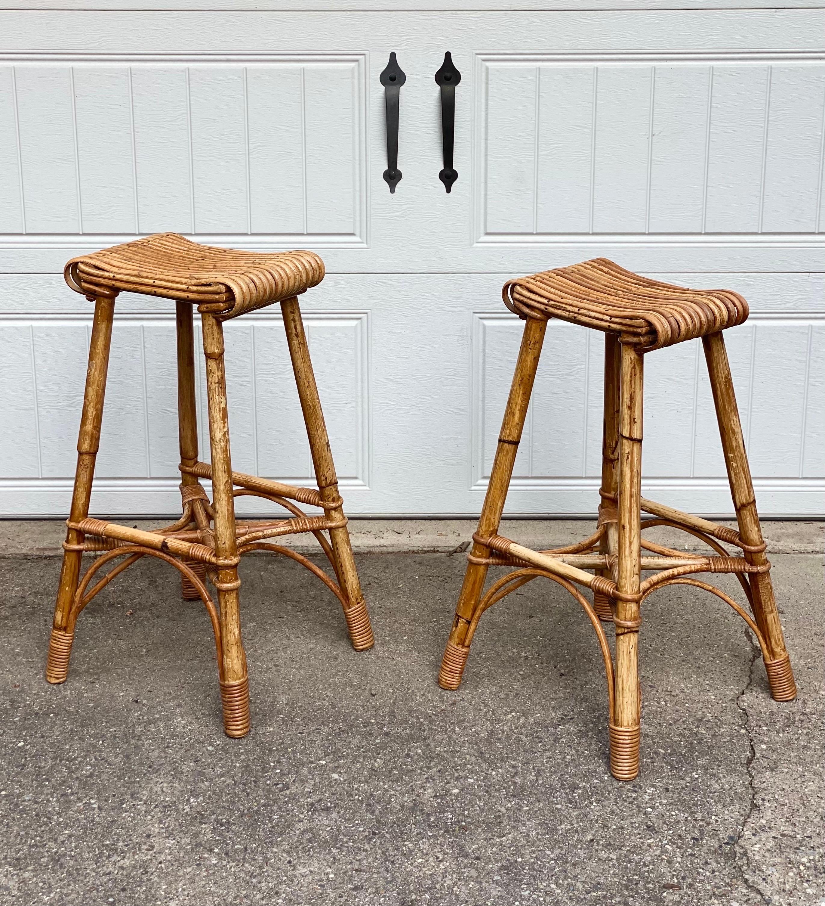 We are very pleased to offer a pair of vintage bar stools by British Company J. Birdekin, circa the 1940s. Handcrafted in Ossett, a market town in West Yorkshire, England, this backless pair showcases the timeless beauty of bamboo, a versatile and