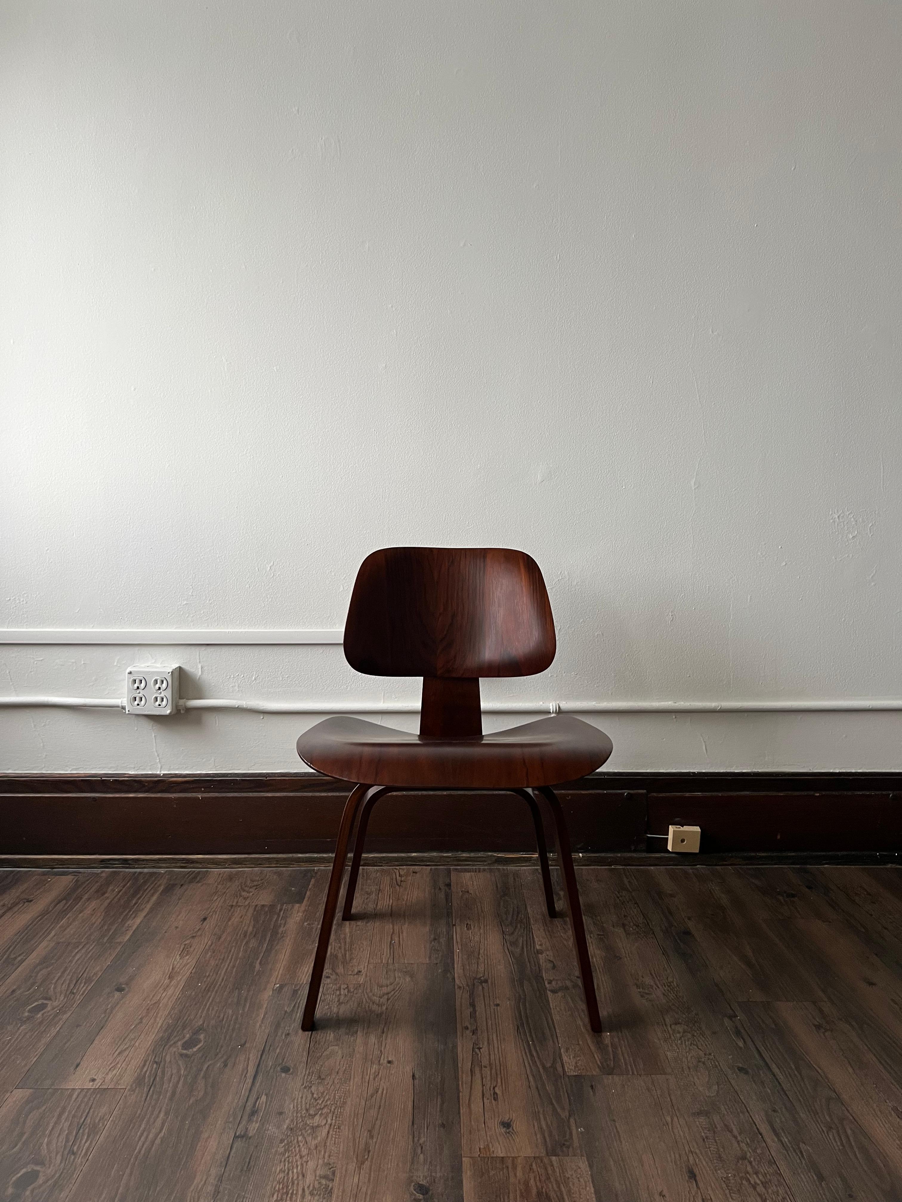 The first chair by Charles and Ray Eames, the DCW changed mid century modernism forever. This rosewood example, bears the uncommon Herman Miller/ Evans Products label.