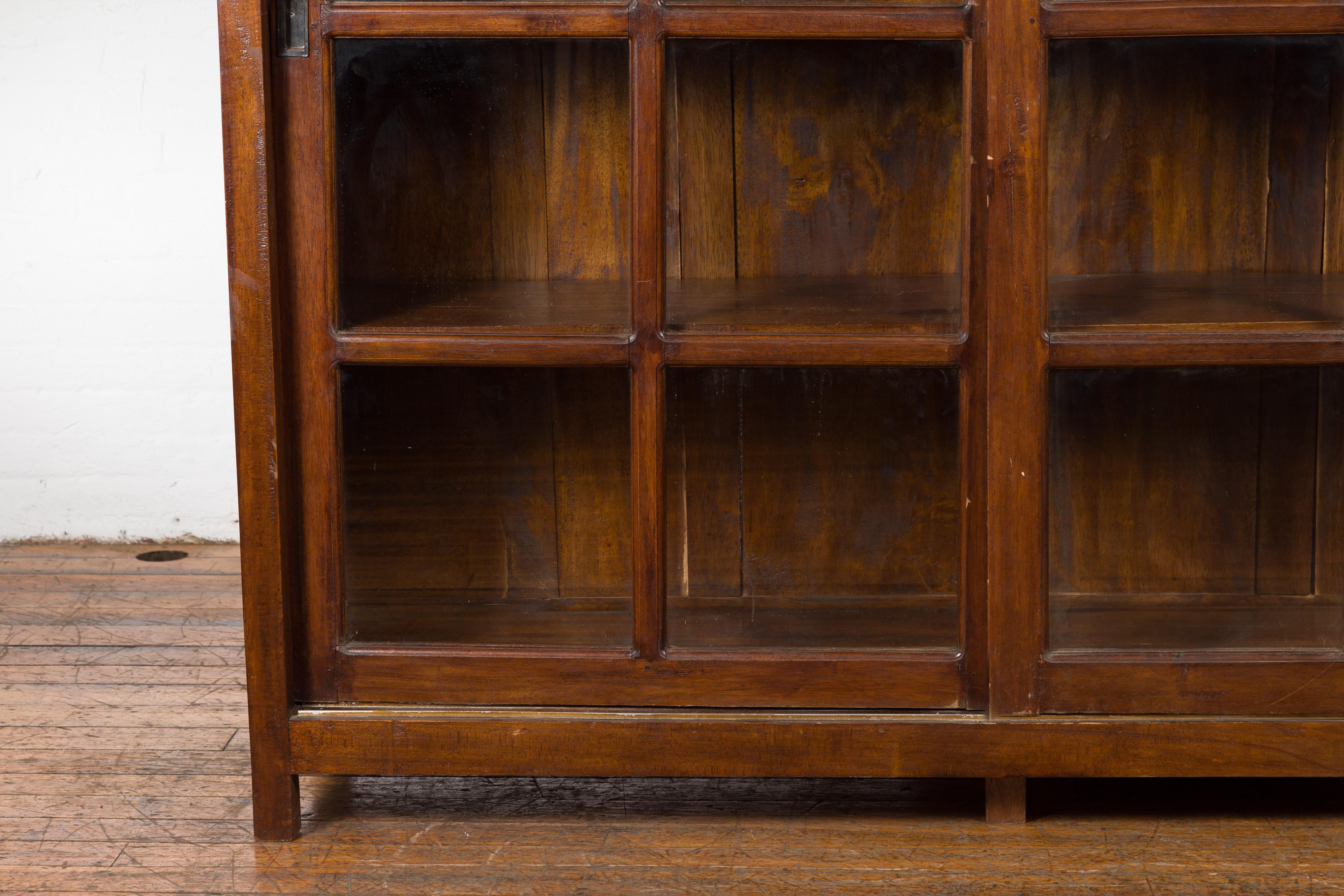 20th Century 1940s Vintage Javanese Brown Wood Bookcase with Sliding Paneled Glass Doors For Sale