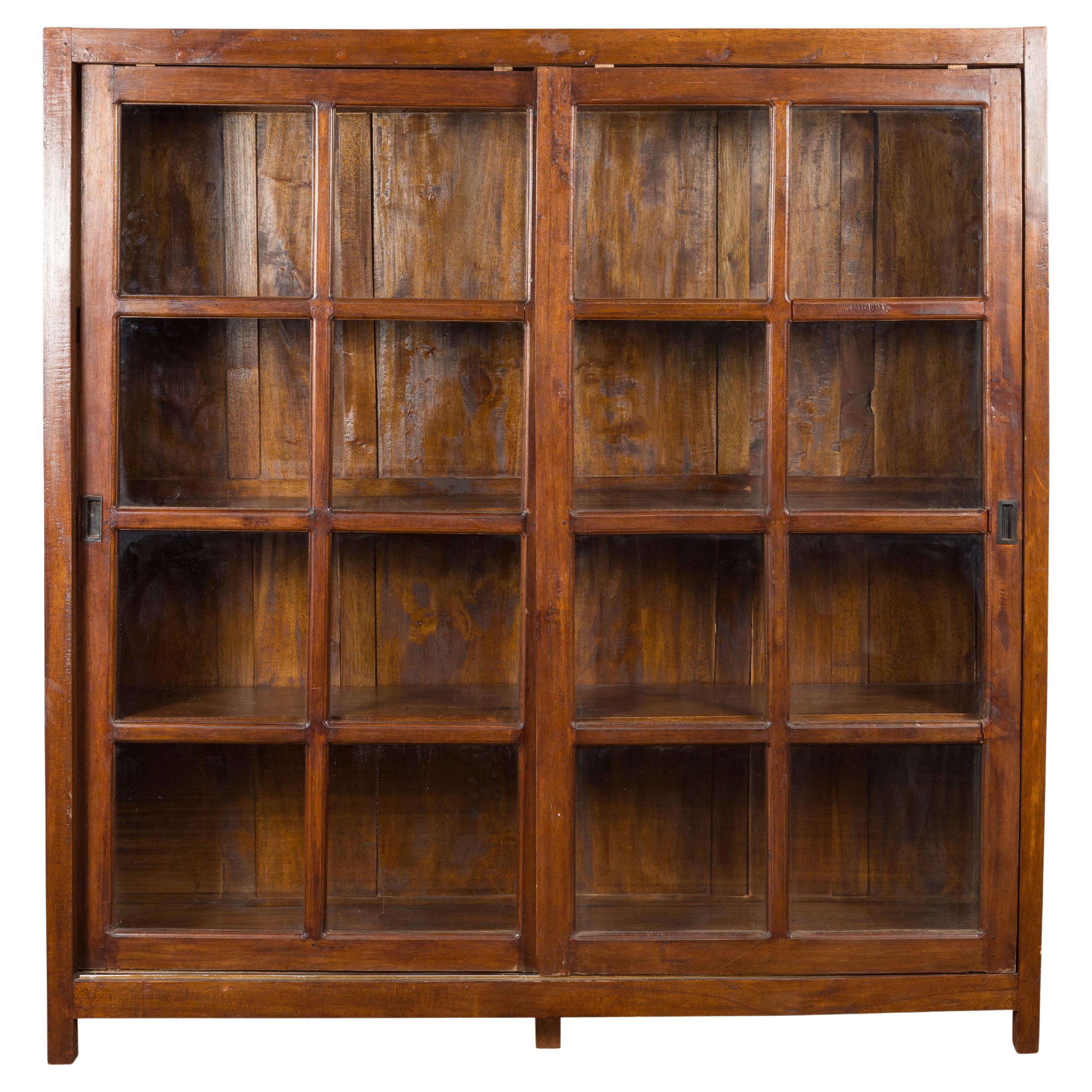 1940s Vintage Javanese Brown Wood Bookcase with Sliding Paneled Glass Doors For Sale