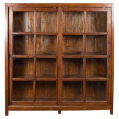 1940s Used Javanese Brown Wood Bookcase with Sliding Paneled Glass Doors