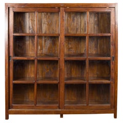 1940s Antique Javanese Brown Wood Bookcase with Sliding Paneled Glass Doors