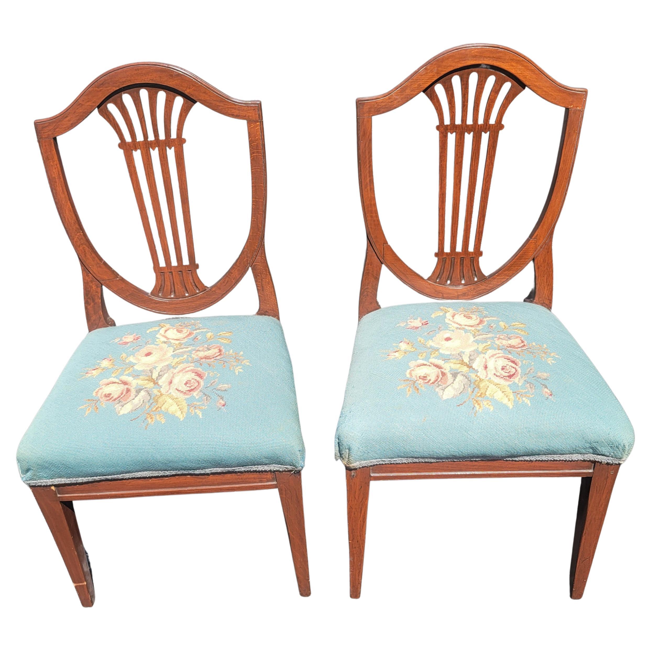 A 1940s pair of Mahogany Shield Back Upholstered Needle Point seat Chairs for your consideration. 
Measure 19.5