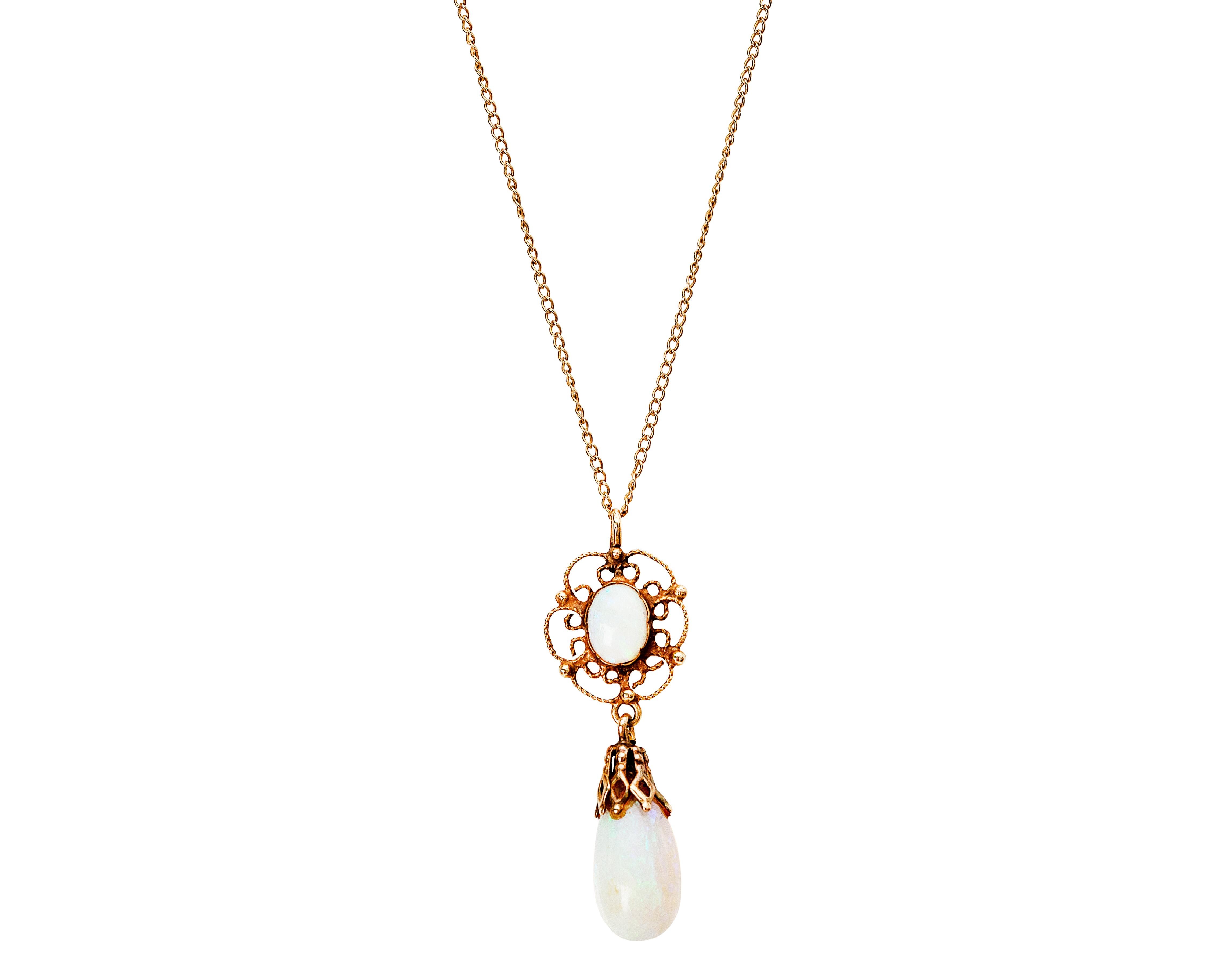 Beautiful 1940s Opal Lavalier Necklace. This stunning necklace features a dull patina 14 karat gold necklace with a gorgeous vintage design pendant. The pendant features 2 opals - one in the center fo the pendant (Smaller of the two), flat embedded