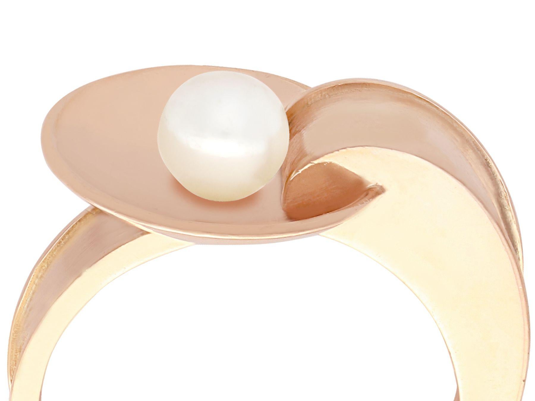 A fine and impressive vintage pearl and 14k rose gold cocktail ring; part of our diverse gemstone jewelry and estate jewelry collections.

This fine and impressive vintage pearl ring has been crafted in 14k rose gold.

The ring has an asymmetric