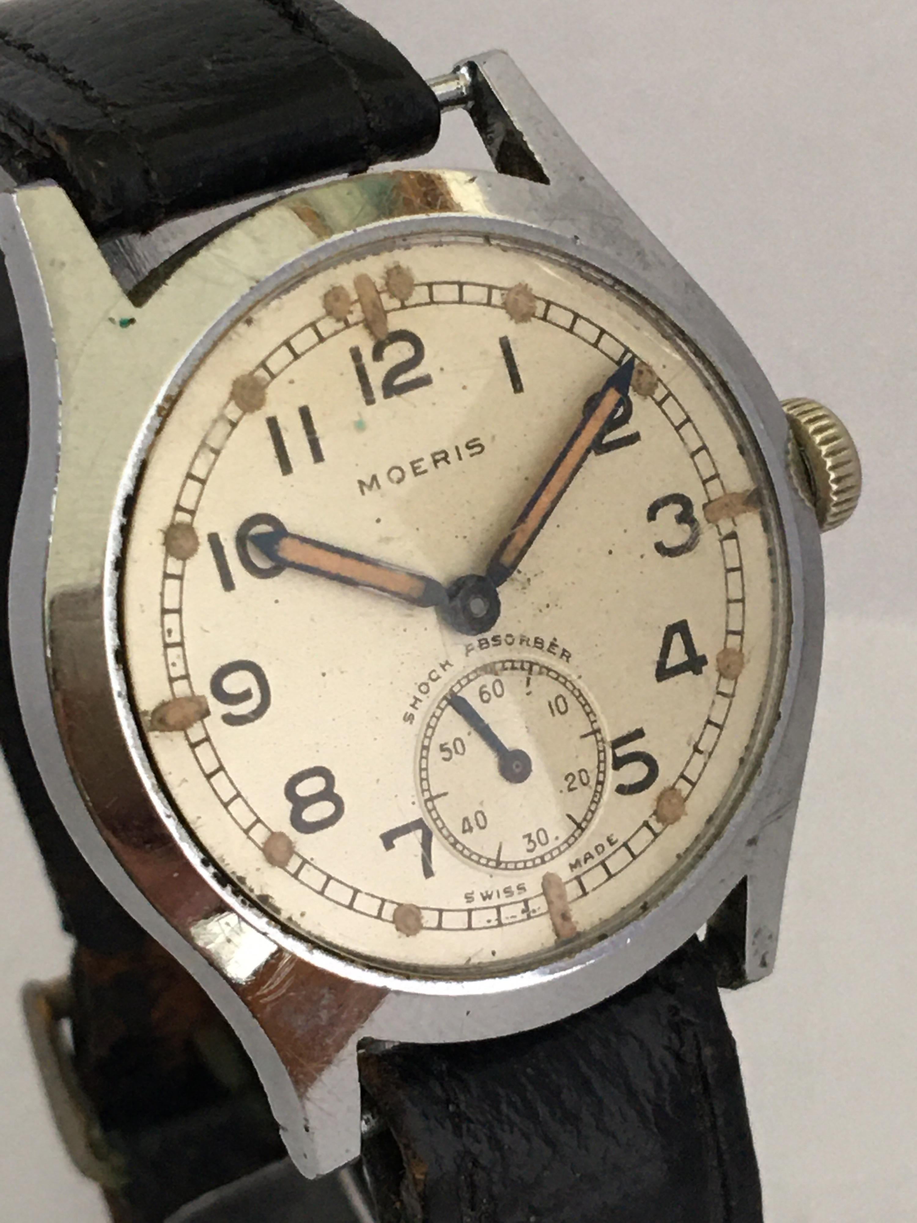 This vintage mechanical Swiss movement Military Watch is working and it is ticking and running well.
Visible signs of ageing and wear as shown. The black leather strap is worn. Please study the images carefully as form part of the description.

