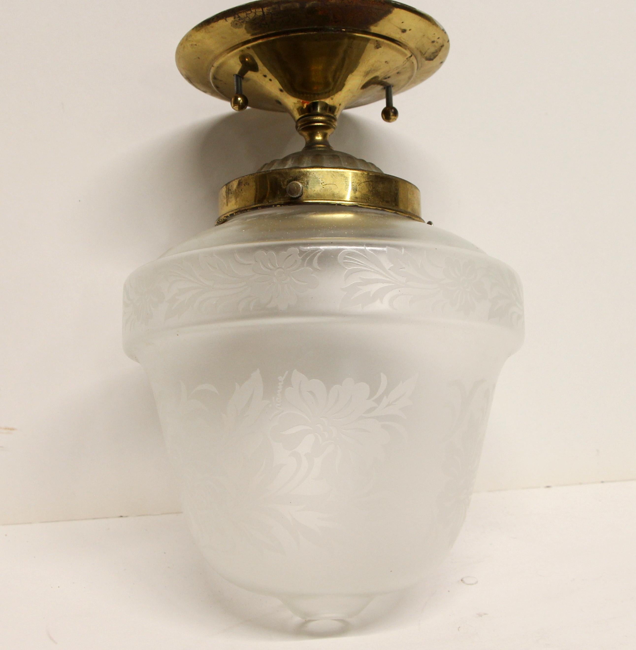 Simple acorn-shaped floral etched glass foyer or hallway light with a brass fitter from the prominent Waldorf Astoria Towers, circa 1940. Waldorf Astoria authenticity card included with your purchase. This can be viewed at one of our New York City