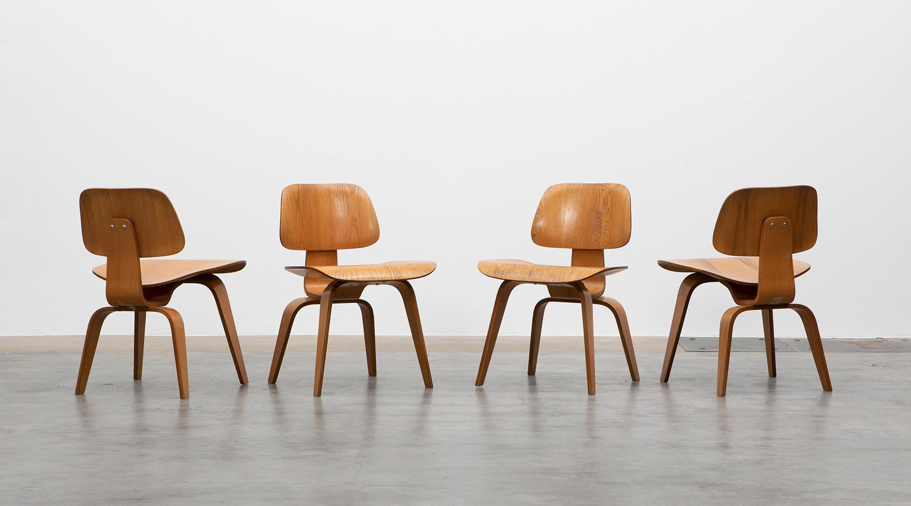 DCW chair, walnut plywood, by designer couple Eames

Iconic set of DCW chairs by famous Charles & Ray Eames. The unusual organic shape of the dining chairs makes clear the designers' innovative use of lumber-core plywood. Manufactured by Herman