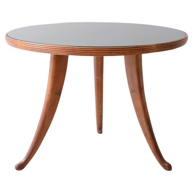 1940's walnut table with sabre legs, striped band and cut glass top.