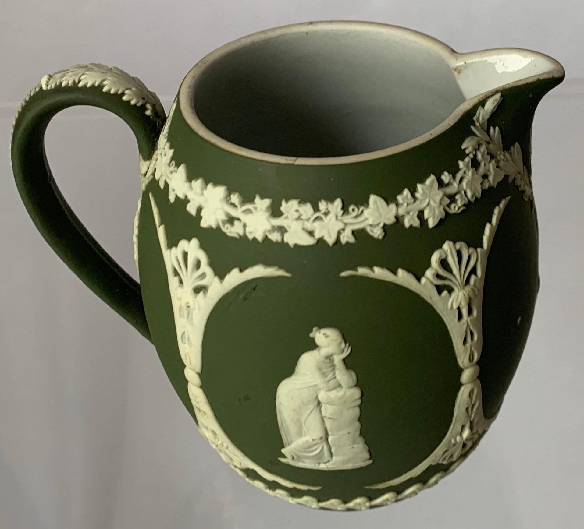 1940s Wedgwood small light green jasperware pitcher or creamer featuring a neoclassical motif. Interior of the pitcher is glazed. Stamped Wedgwood on the underside and stamped 48 indicating it was made in 1948.