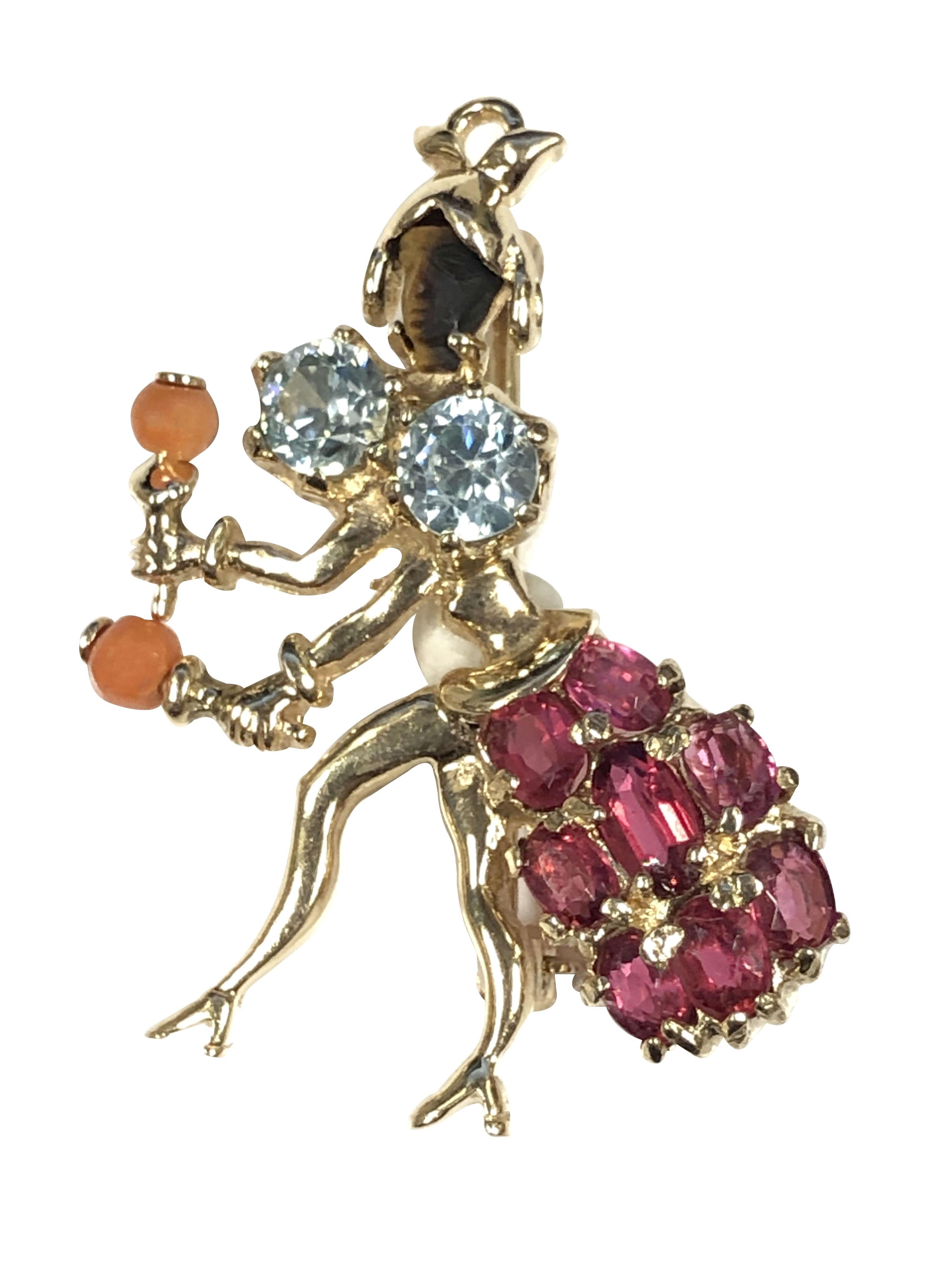 Circa 1940s Marimba Dancer brooches, these very whimsical and detailed Brooches are 14k Yellow Gold and each measure 1 1/2 inches in length X 1 inch, each is set with Rubies, Sapphires, Aquamarine, Coral, Rock Crystal and each has a carved face of