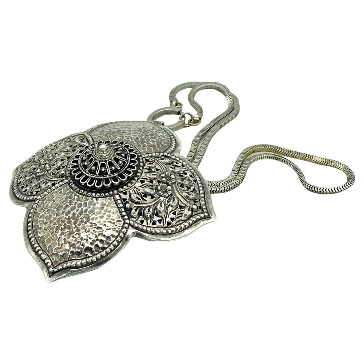 This is a 1940s 12K white gold filled necklace with a 17 mm spring ring. It connects with a large hand made Southern China Mountain style detailed textured sterling silver pendant. 

Our vintage jewelry collection and original creations are all